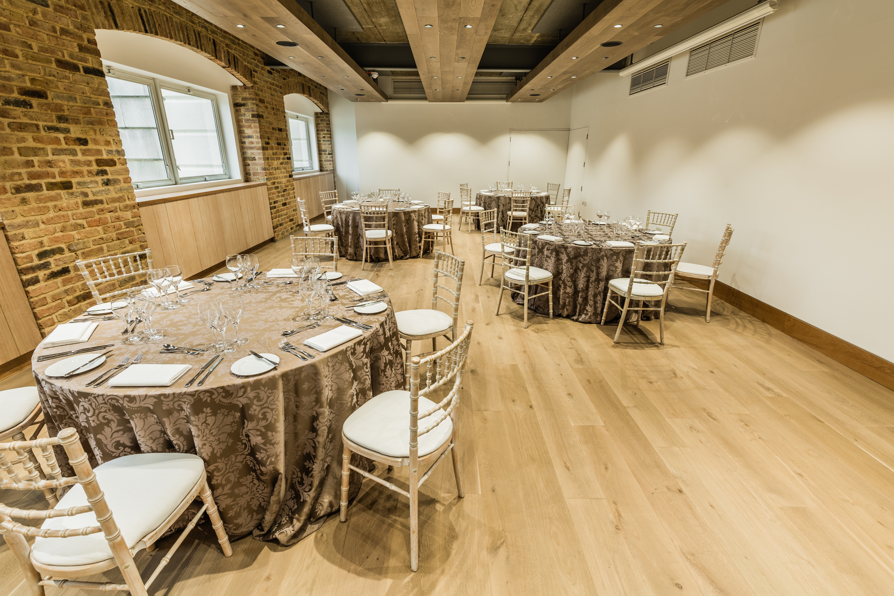 Elegant event space with round tables, ideal for gatherings and receptions at Glaziers Hall.