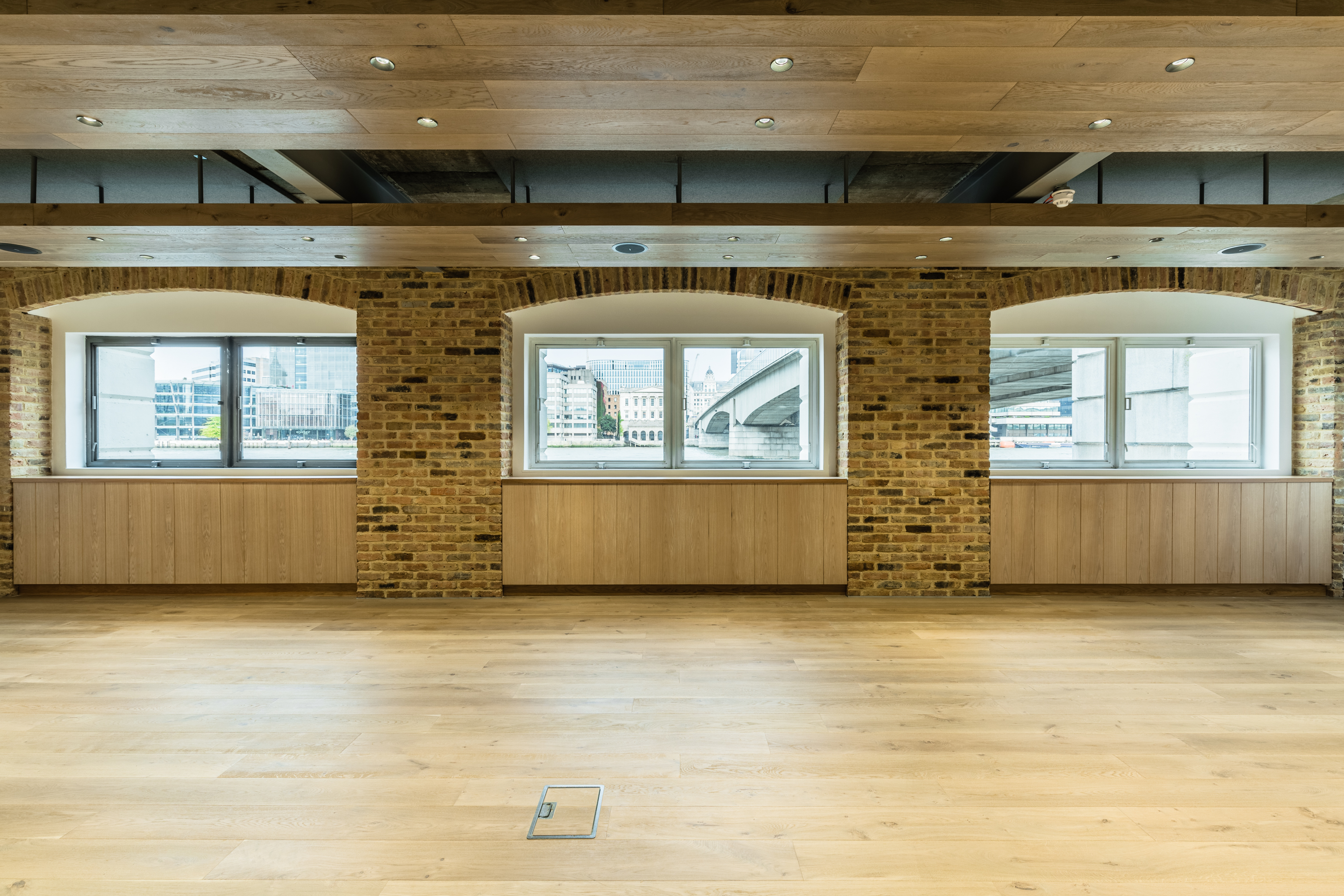 Versatile event space in Glaziers Hall with large windows, ideal for meetings and gatherings.