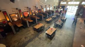 Spacious event venue with warm lighting, ideal for corporate meetings and social events.