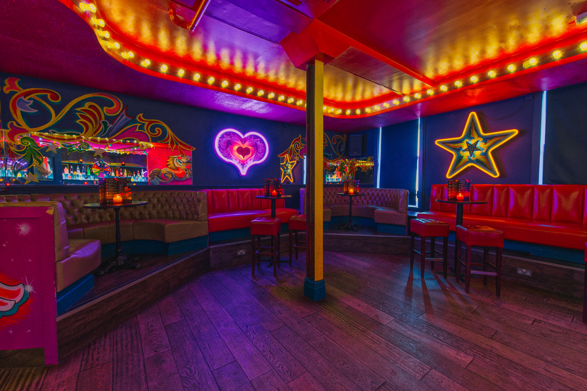Vibrant Fairground 1 venue with neon decor, perfect for themed events and parties.