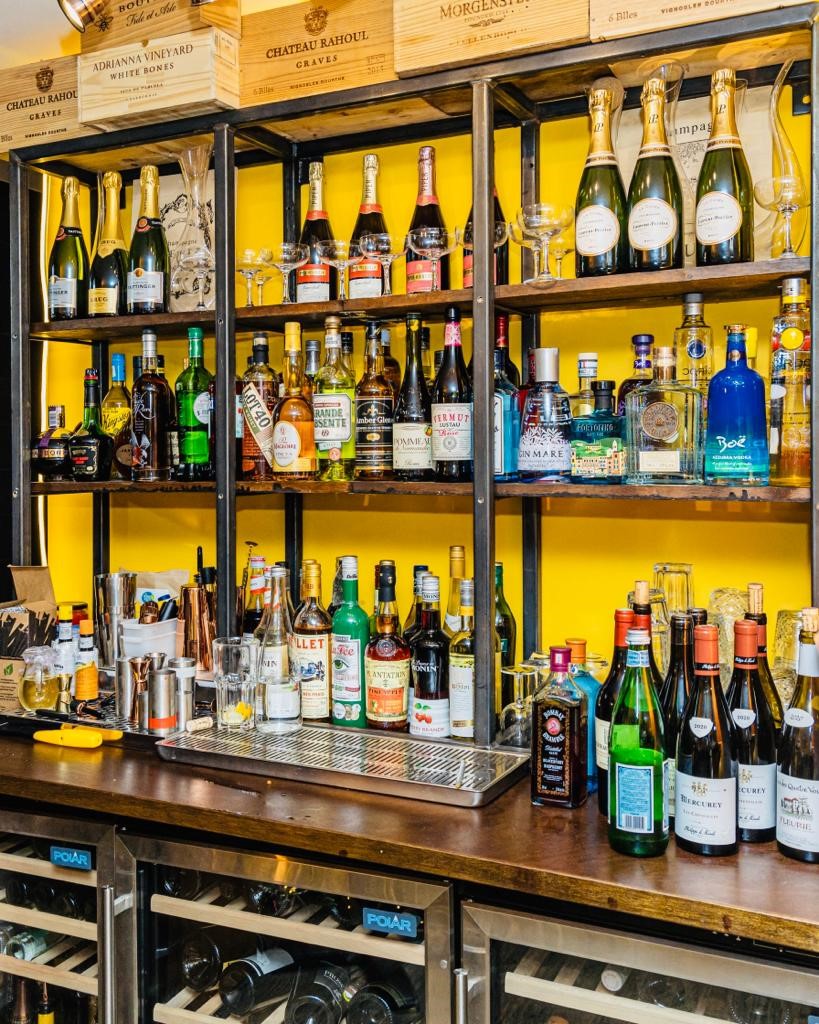 Whole Venue at Clemence Bar with vibrant yellow backdrop, ideal for events and celebrations.