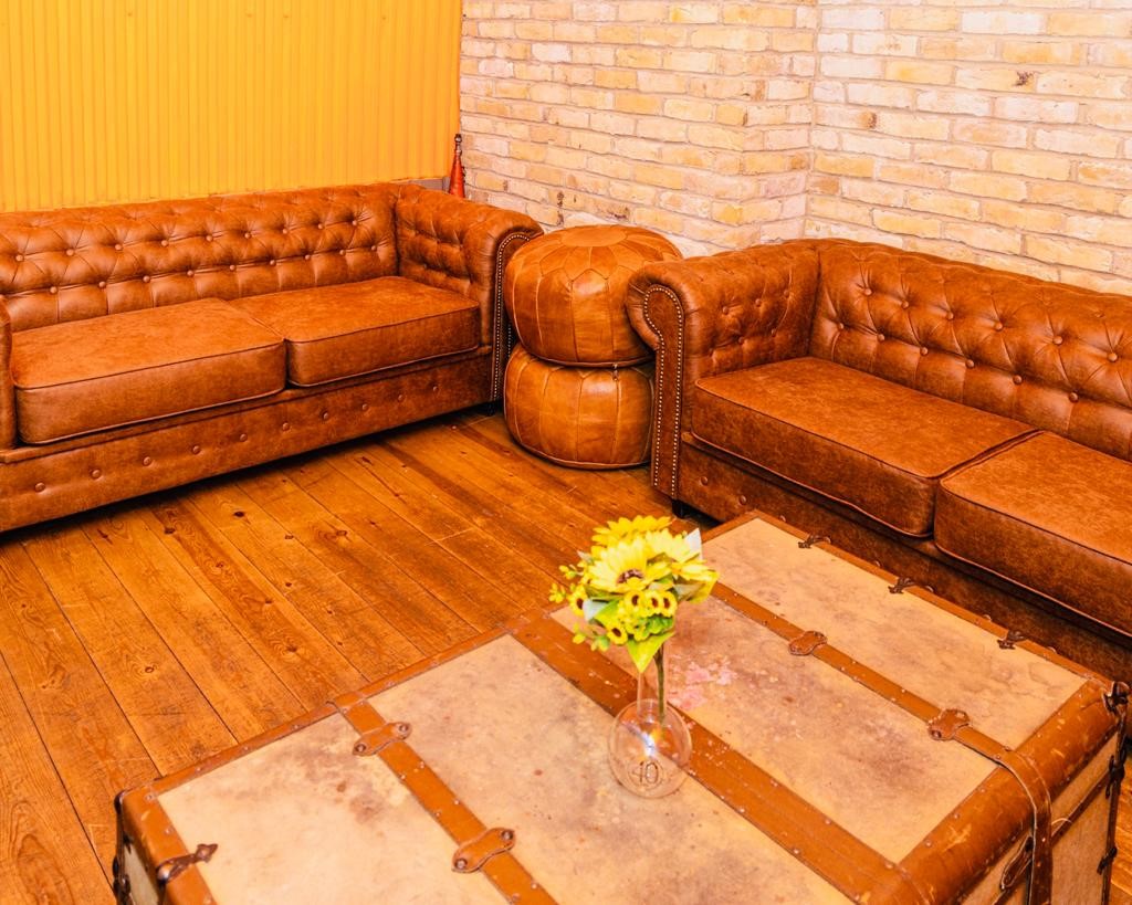 Stylish lounge with tufted leather sofas for networking at Maltby Street Wine House.