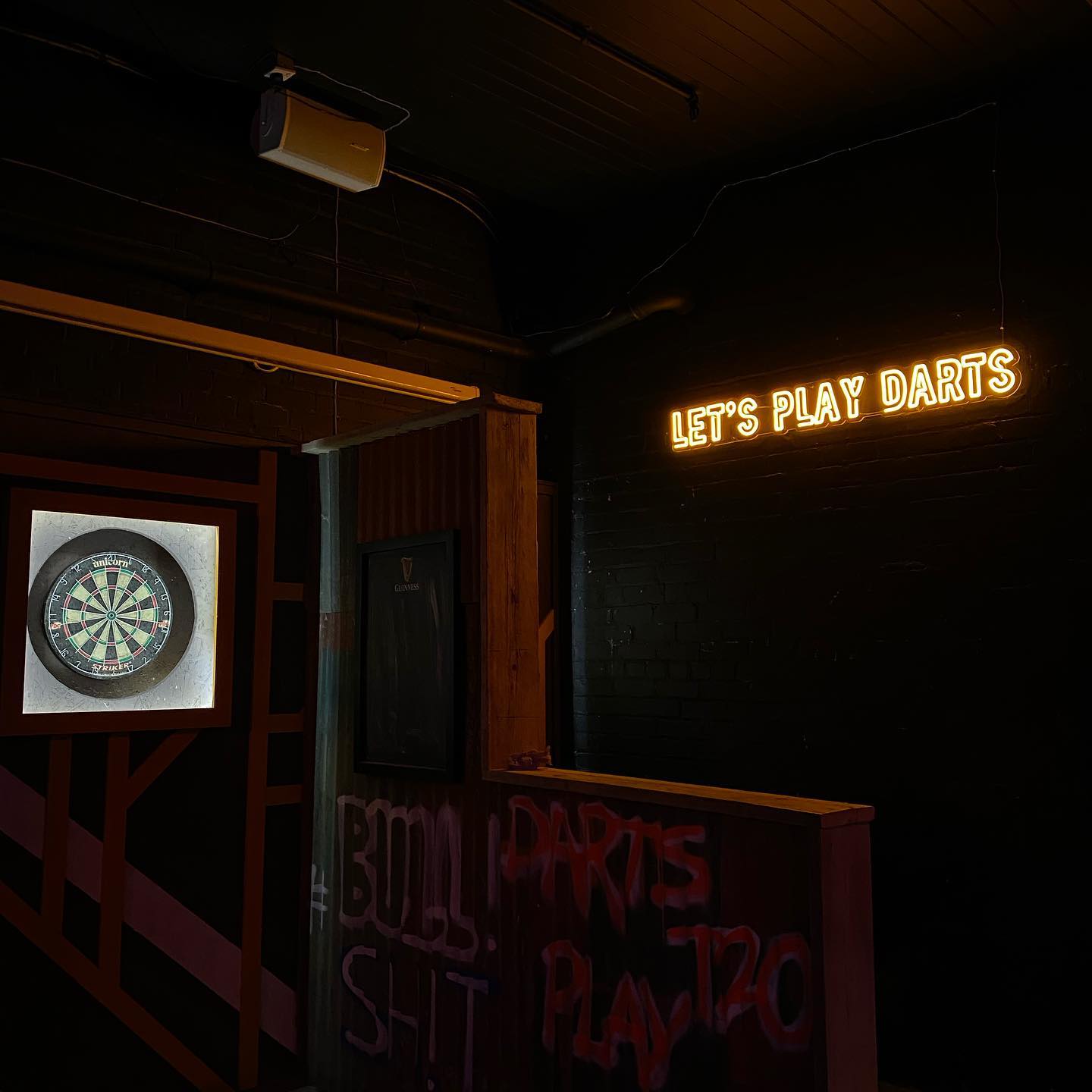 Vibrant event space with dartboard for team-building and social gatherings at The Lost Weekend.