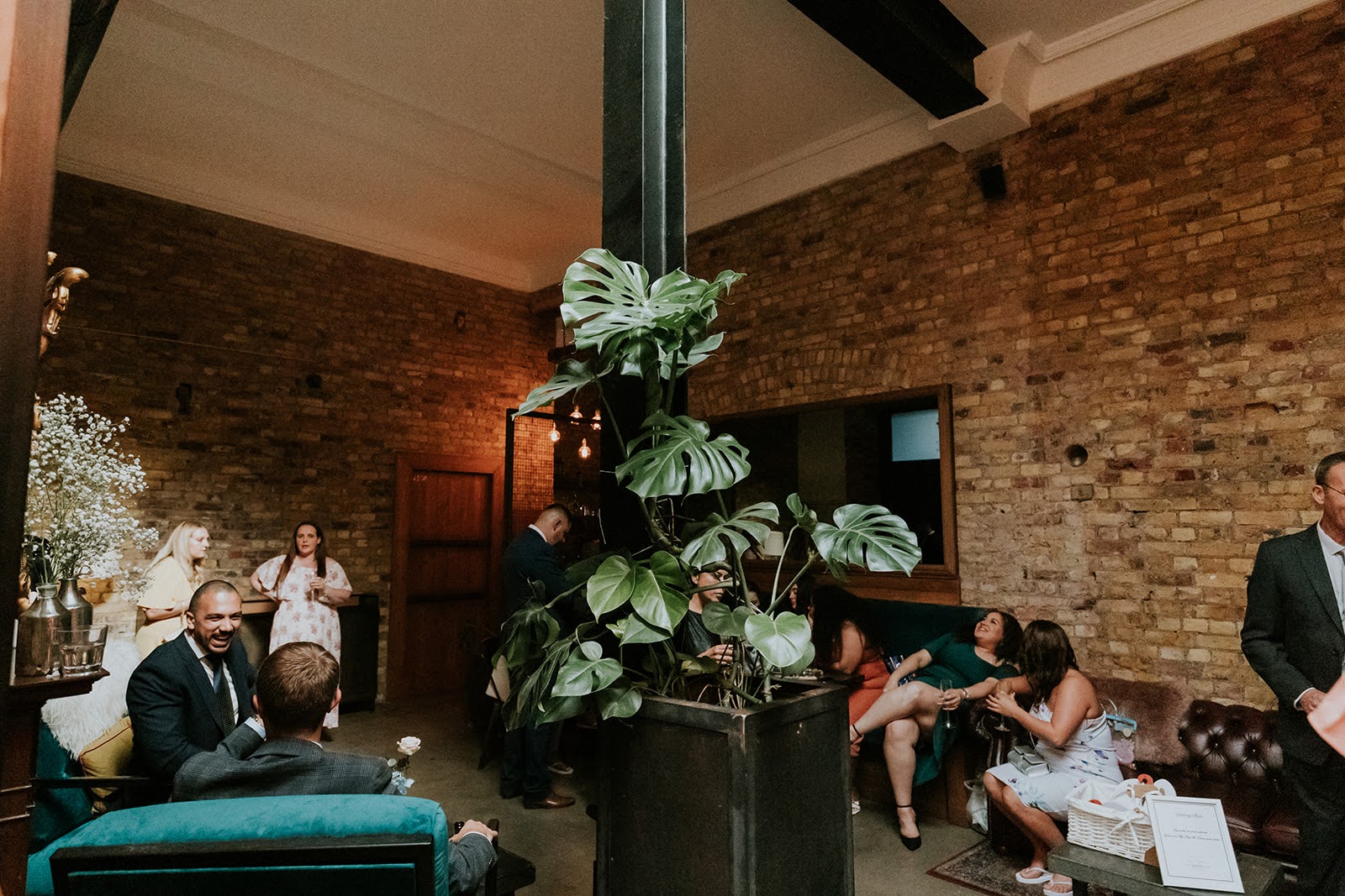 Cozy event space with exposed brick, ideal for networking and gatherings at TheHackney.co.