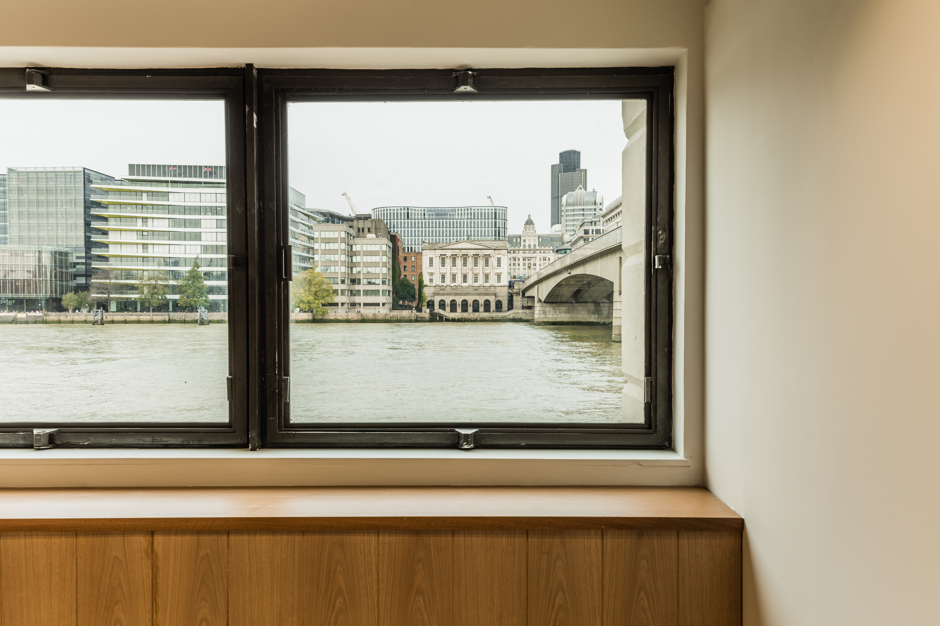 Thames Room at Glaziers Hall: modern meeting space with city skyline views, ideal for events.