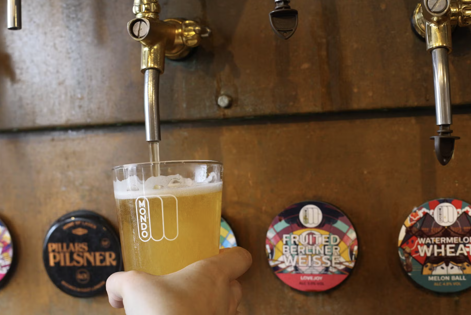 Vibrant Mondo Brewing taproom with sleek beer taps, ideal for networking events.