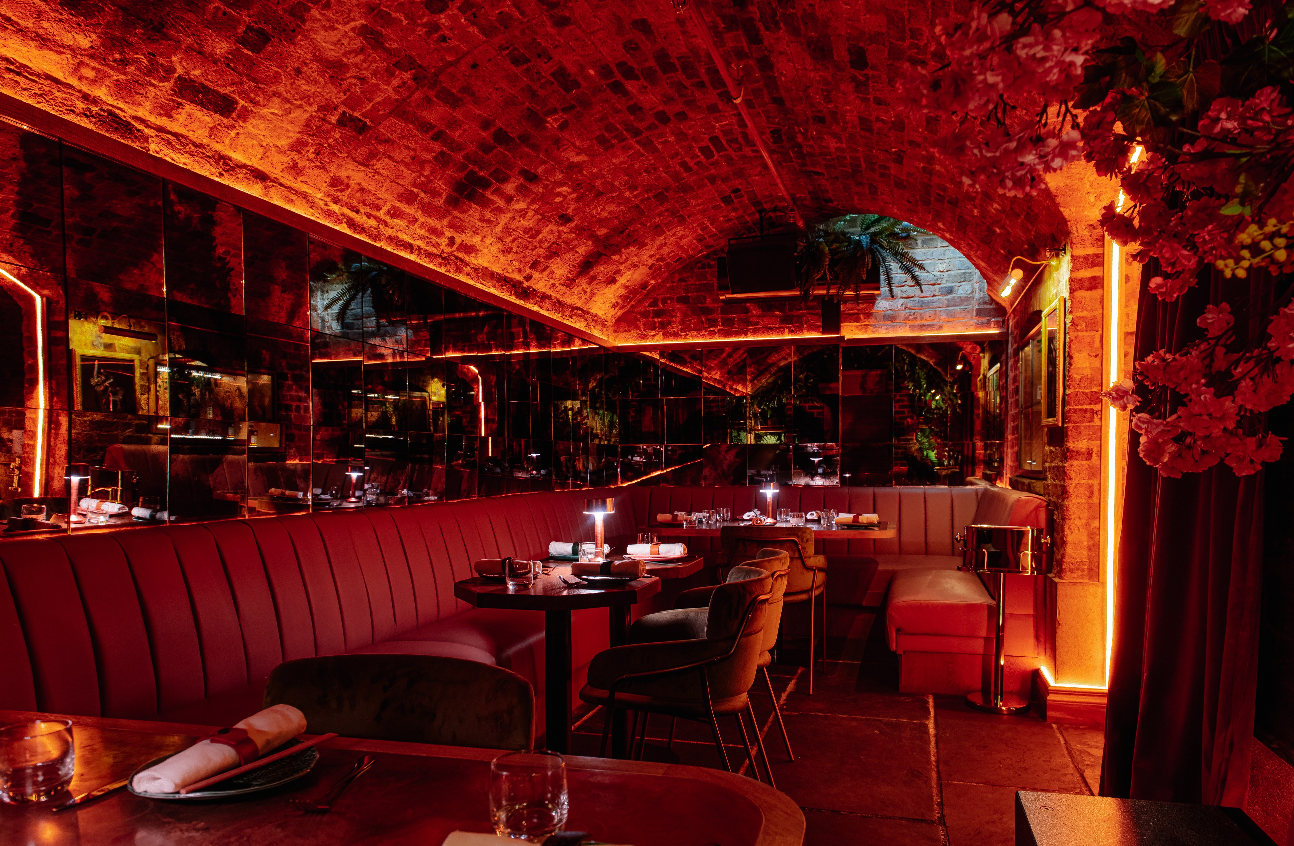 Semi-exclusive VIP area in Cache Cache with warm red lighting for upscale events.