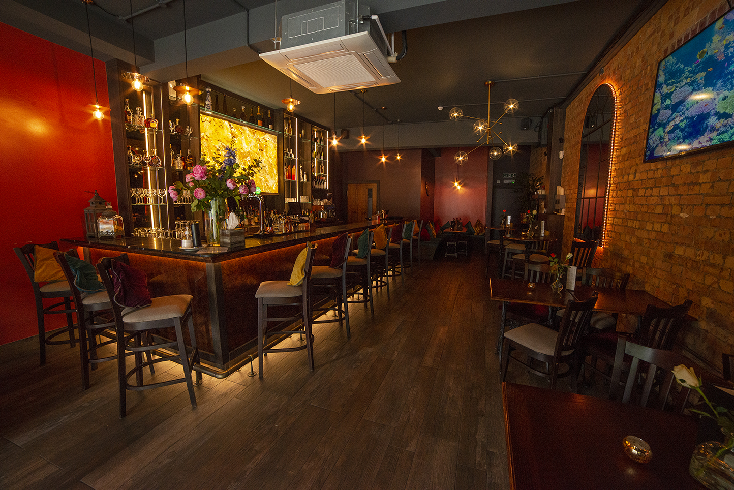 Stylish bar with warm lighting, perfect for networking events and intimate gatherings.