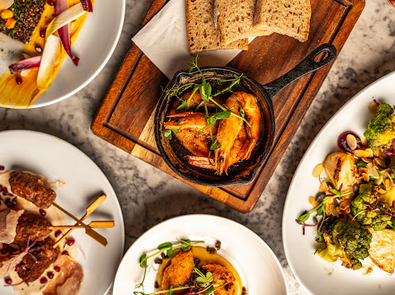 Gourmet dishes with sizzling shrimp centerpiece at The Store Croydon event venue.