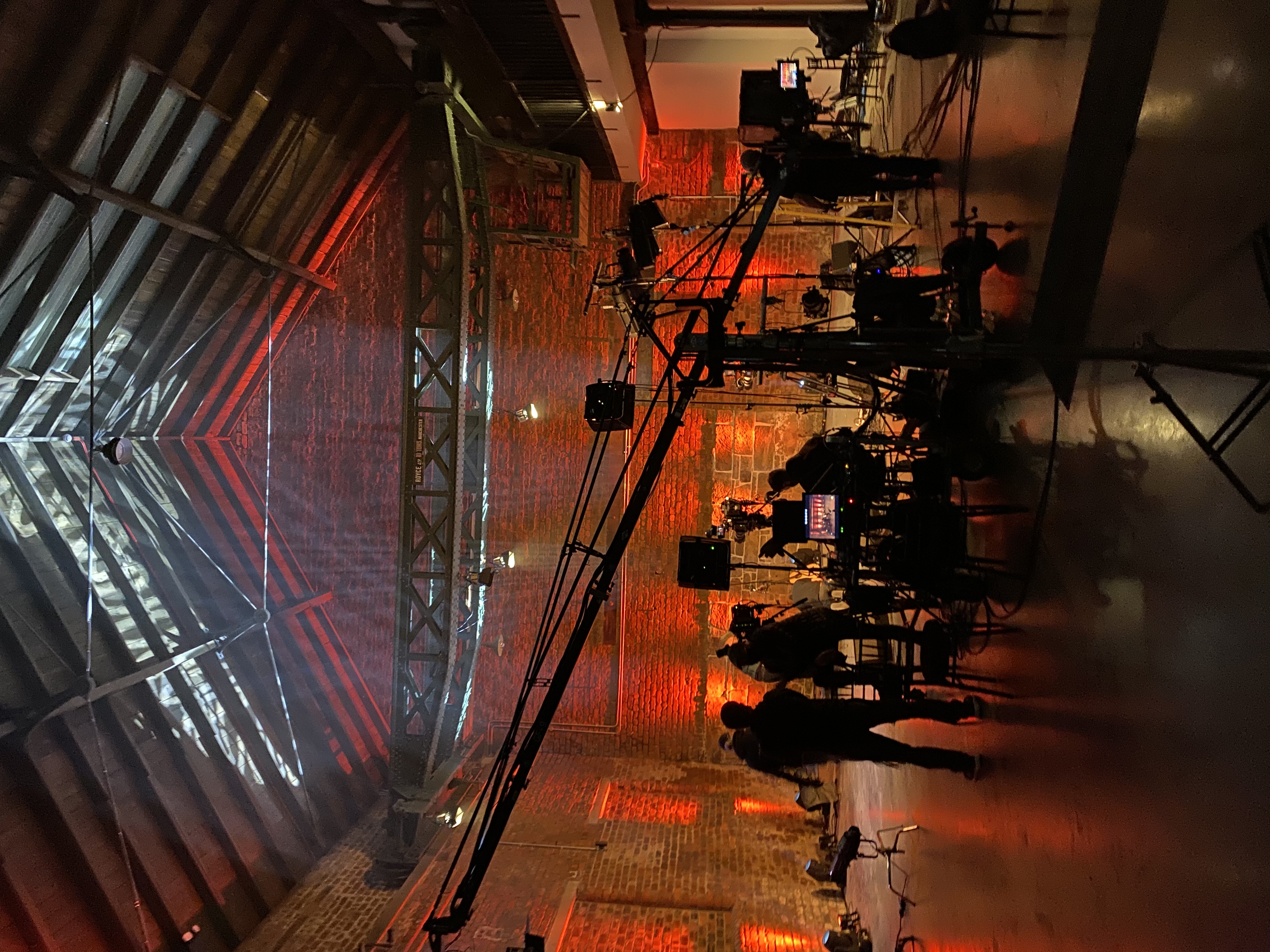 Dynamic event setup with strategic lighting in rustic venue for impactful meetings.