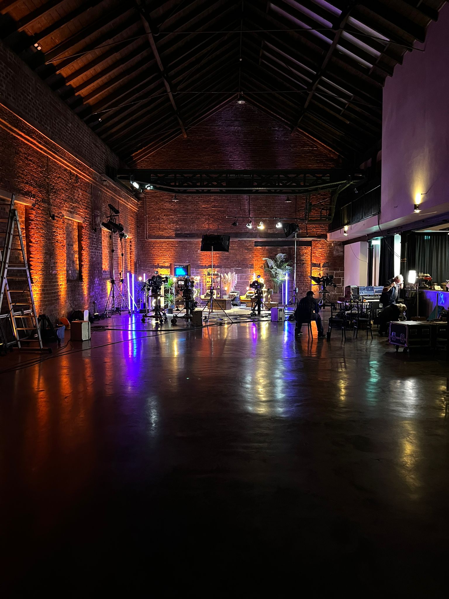Versatile event space with warm lighting, ideal for live productions and creative events.