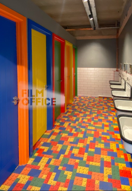 Vibrant restroom at Renegade Urban Winery with colorful doors for events.