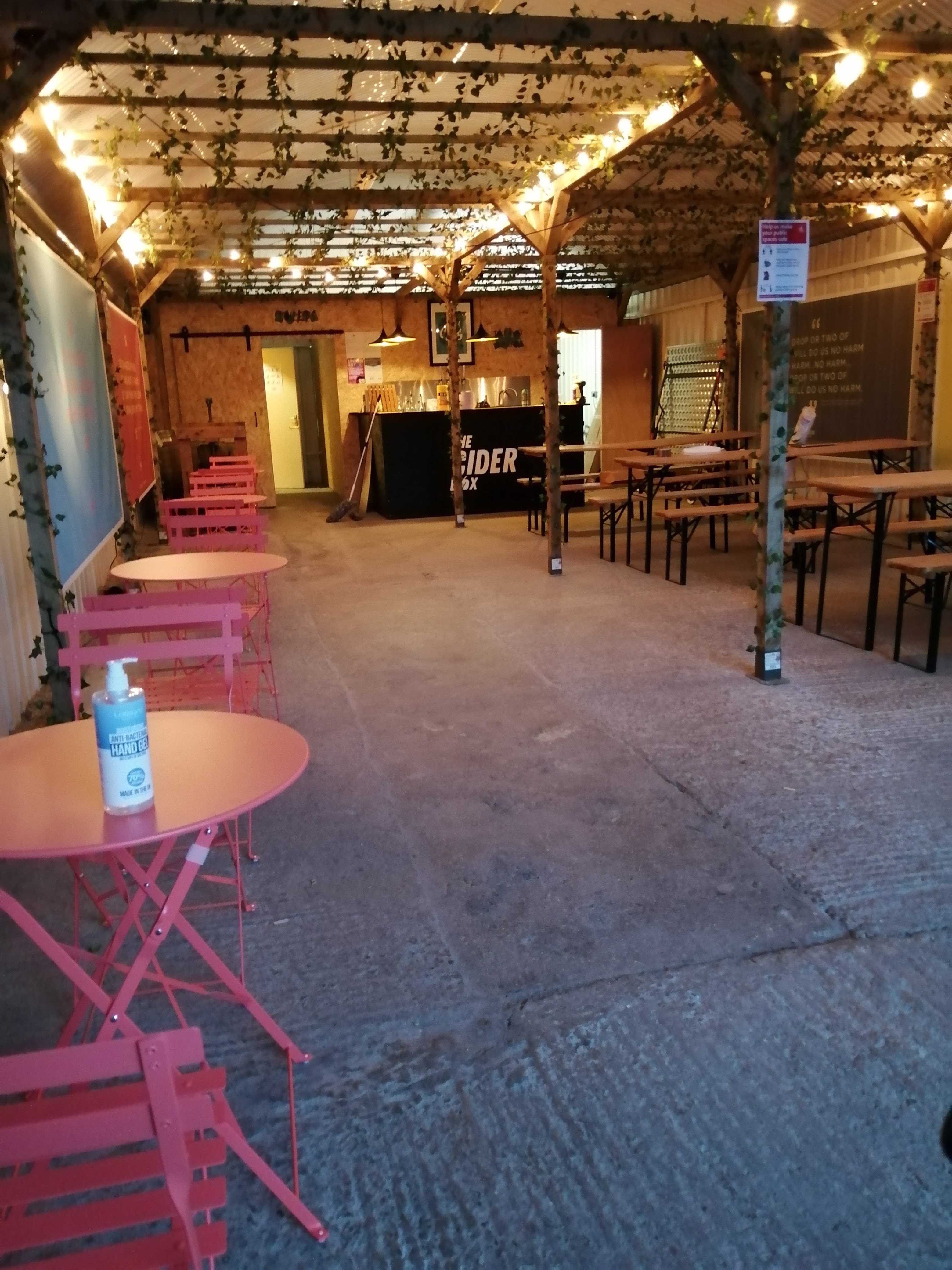 Versatile event space with pink bistro tables for networking and casual gatherings.