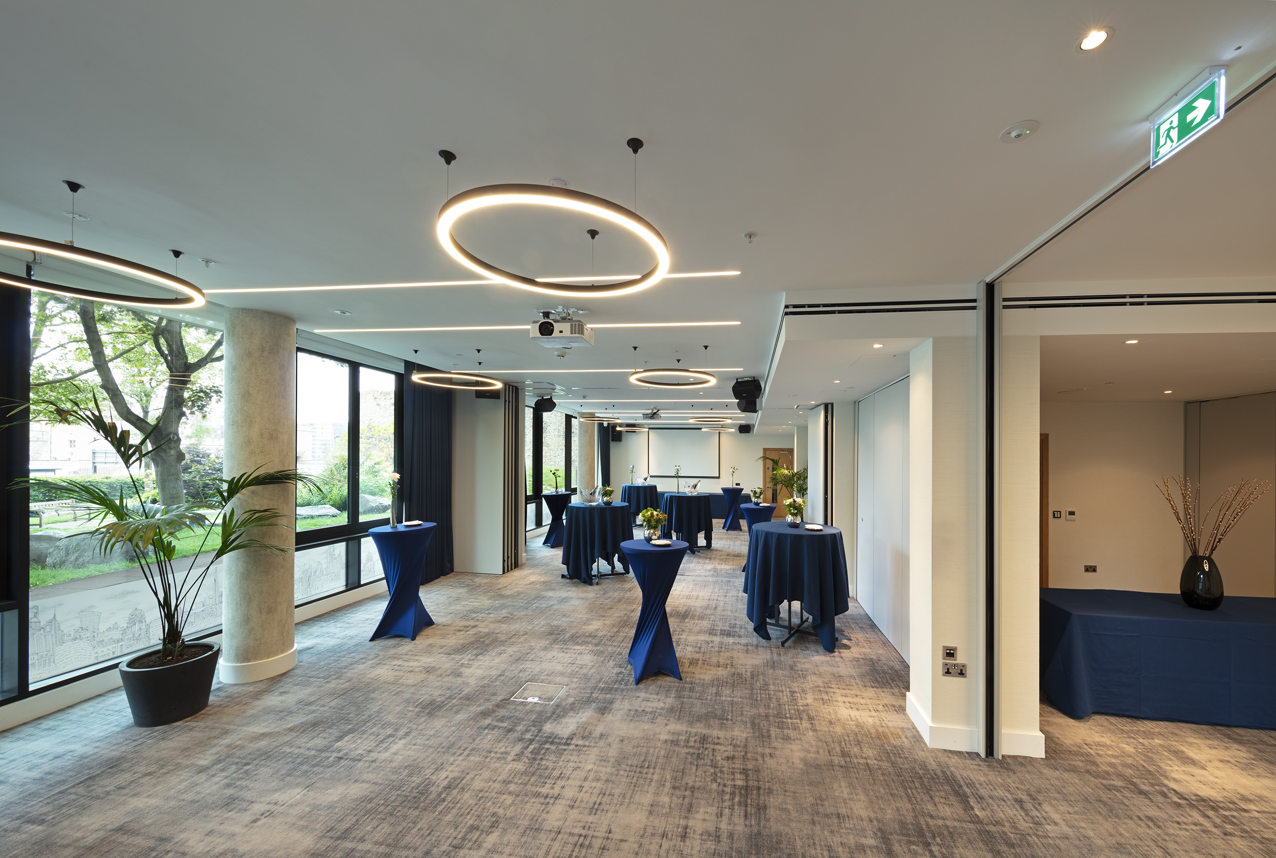 Royal Suite event space with navy tables, perfect for networking and gatherings.