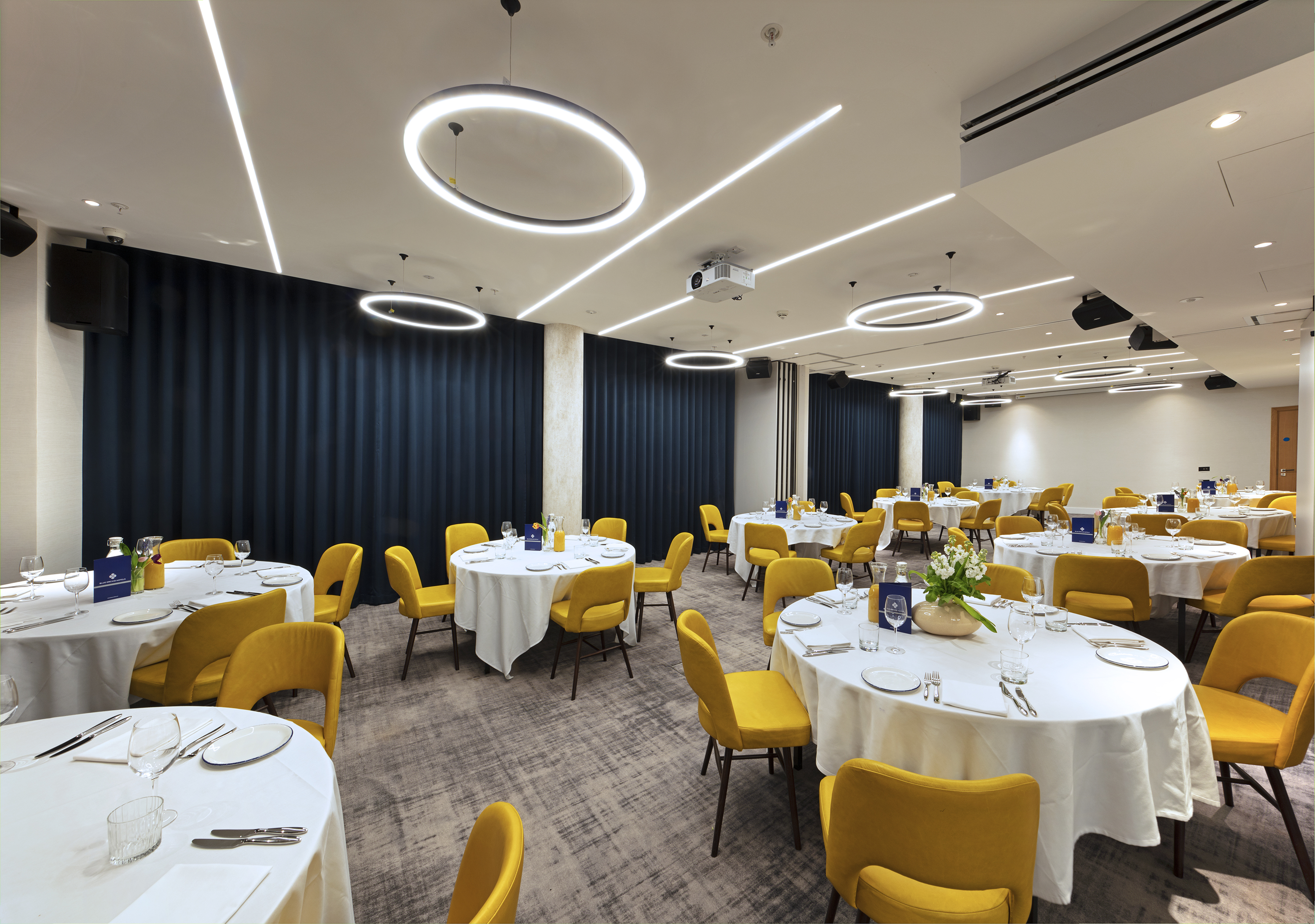 Royal Suite event space with round tables, ideal for corporate meetings and formal dinners.