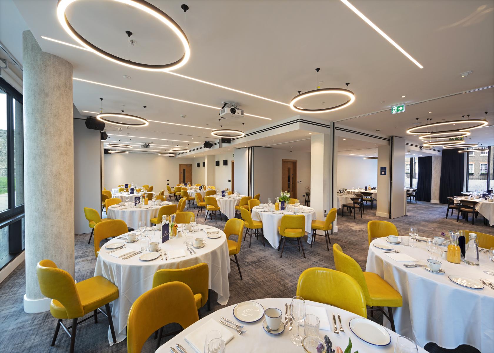 Royal Suite banquet setup with white linens and yellow chairs, perfect for events.