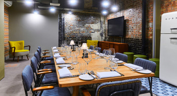 Stylish meeting space with wooden table, ideal for executive meetings and private dinners.