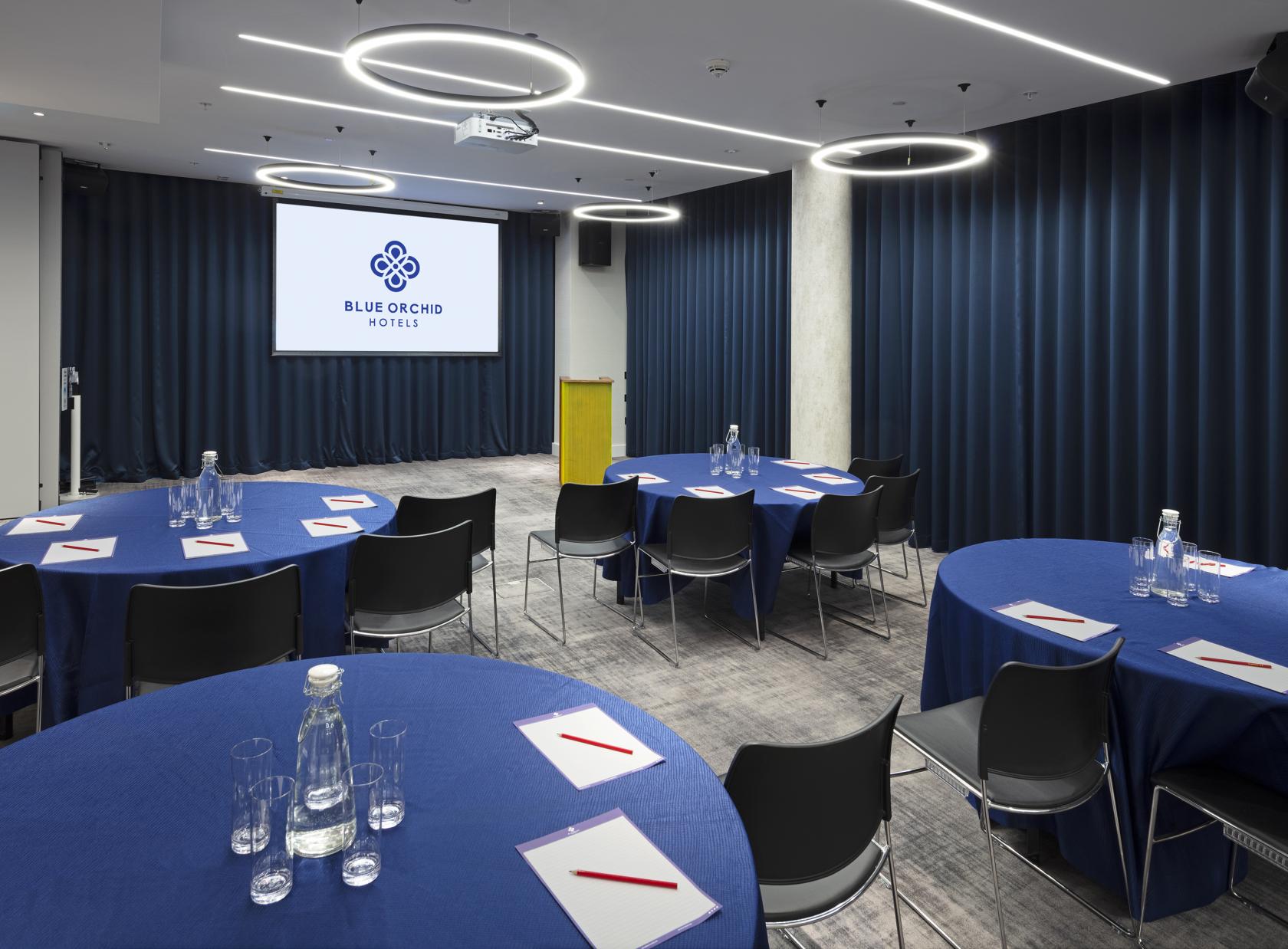 City Suite meeting space with blue linens, ideal for professional events and presentations.