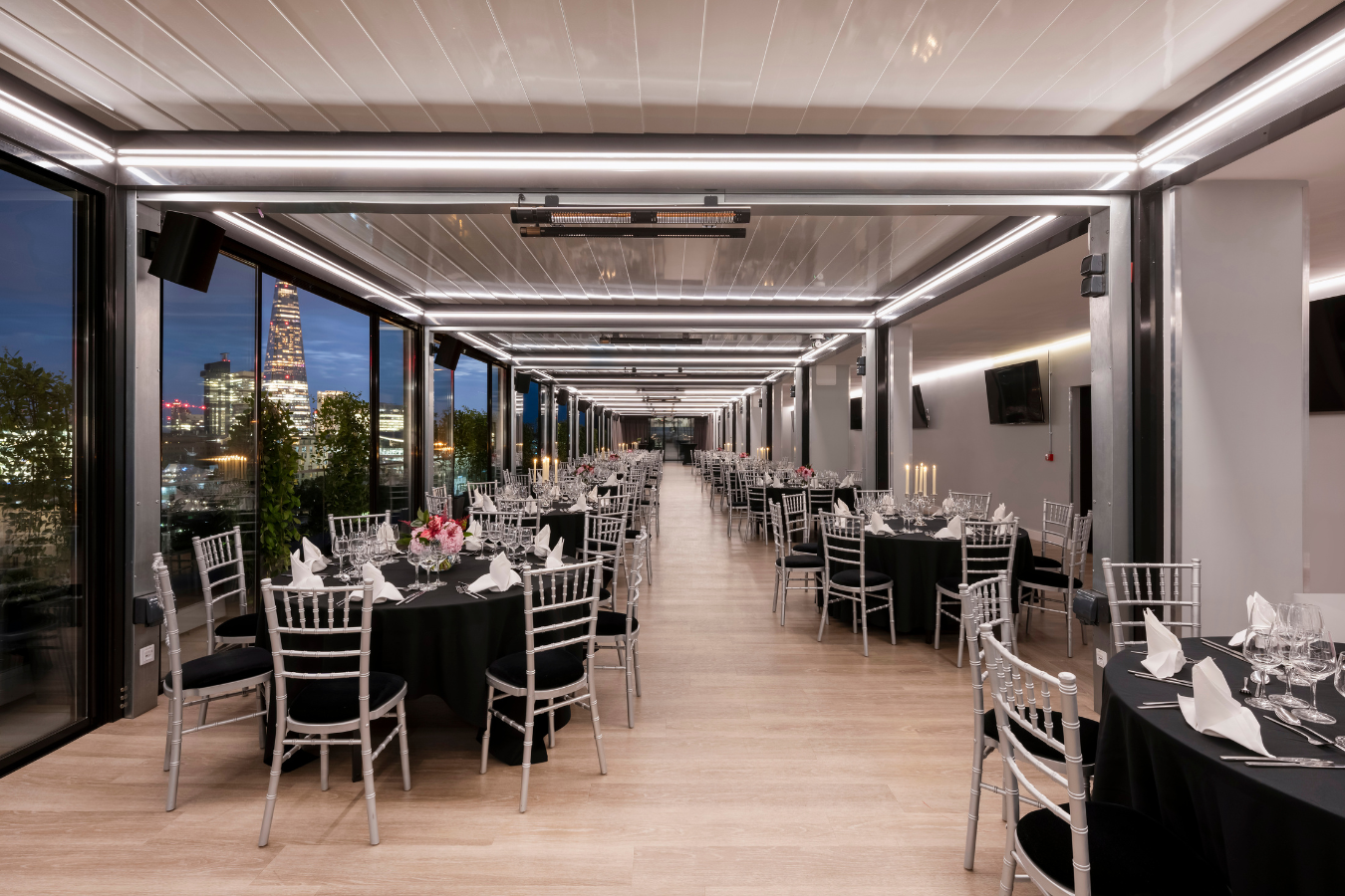 Elegant event space at Skyline London with round tables, ideal for corporate gatherings.