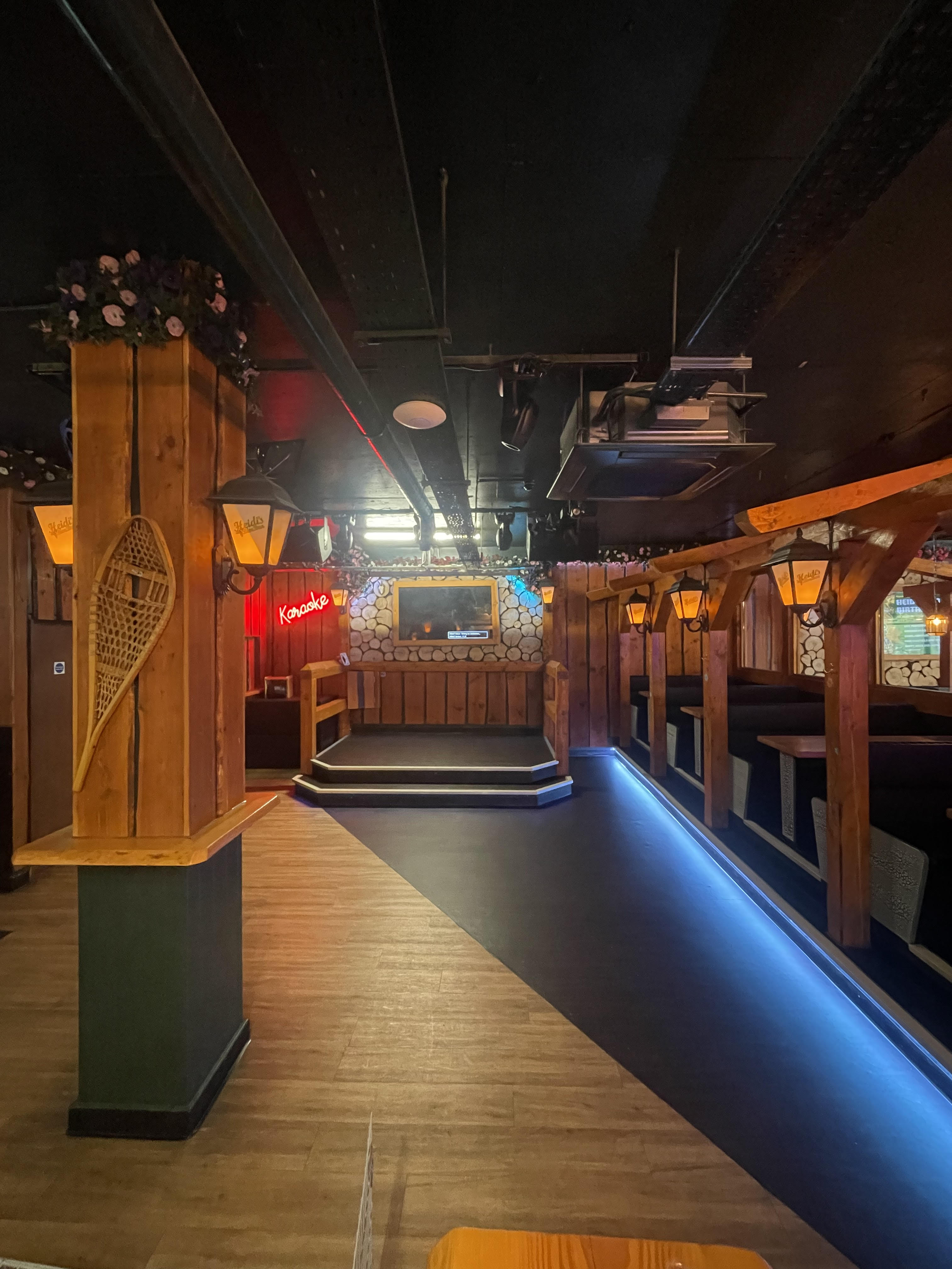 Cozy rustic bar with warm wood accents, ideal for intimate gatherings and events.