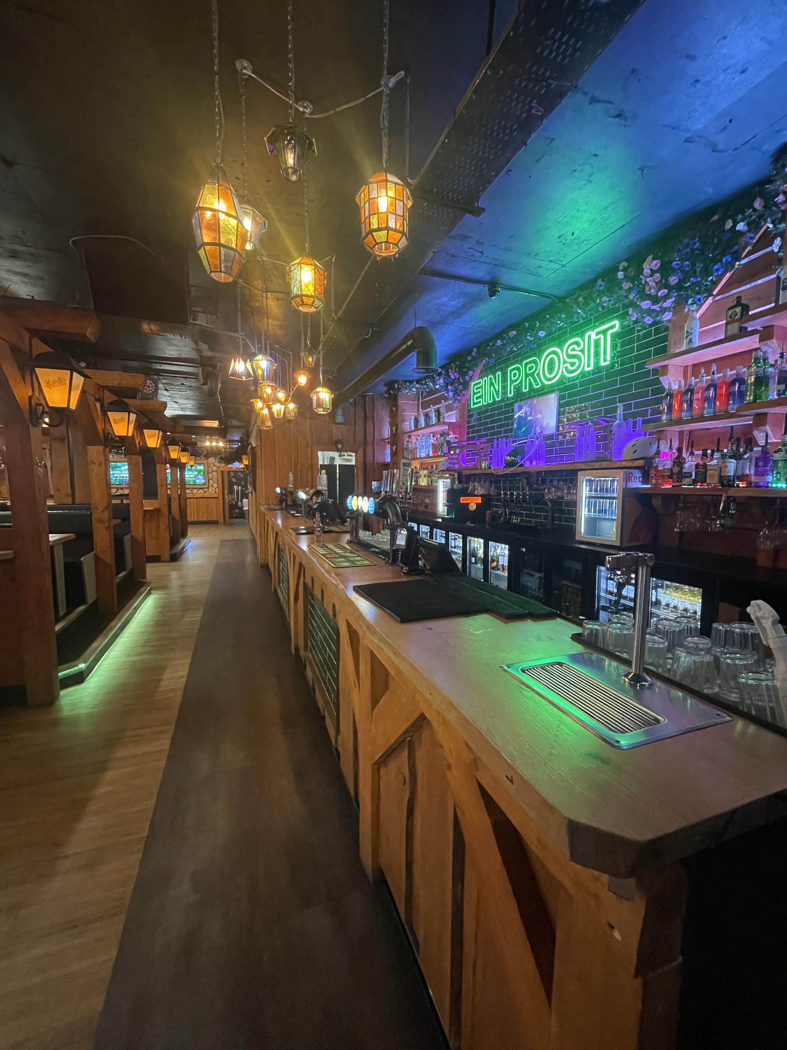 Vibrant bar at Barbara's Bier Haus, perfect for events with rustic decor and warm lighting.