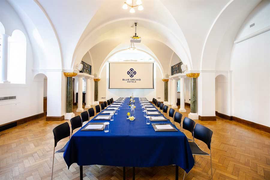 Boardroom setup in Chapel Suite at The Wellington, historic vaulted venue for executive meetings.