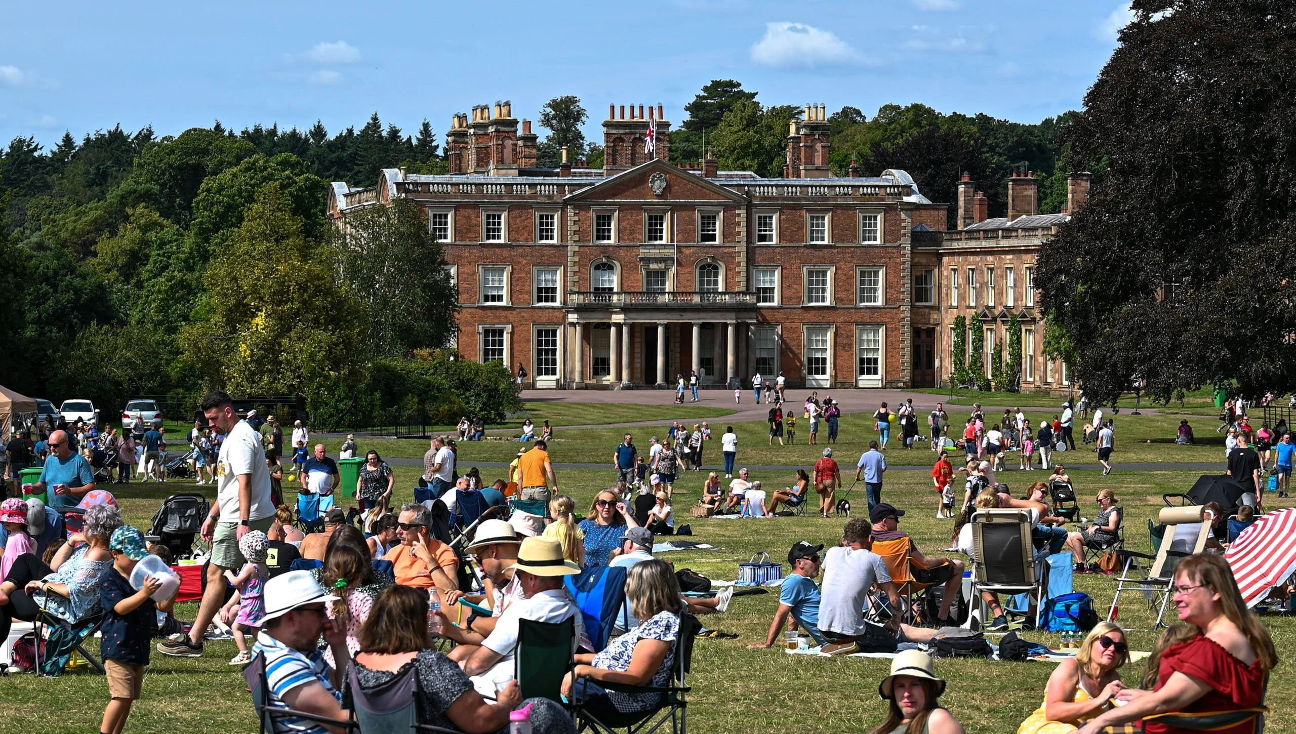 Vibrant outdoor event at Weston Park with elegant architecture, ideal for corporate retreats.