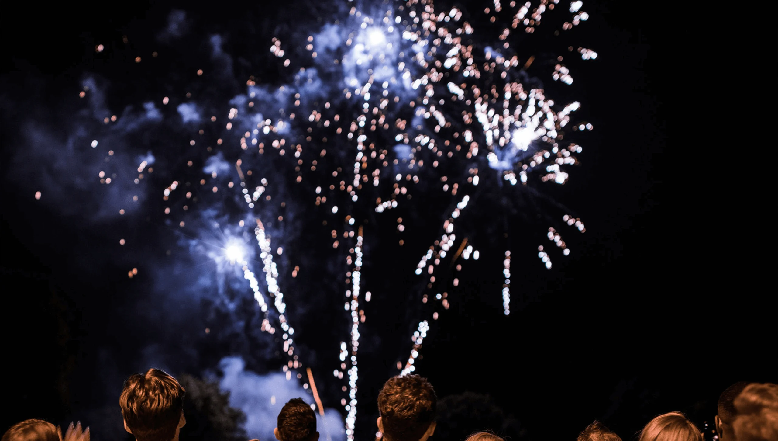 Captivated audience enjoying vibrant fireworks at Weston Park celebrations.