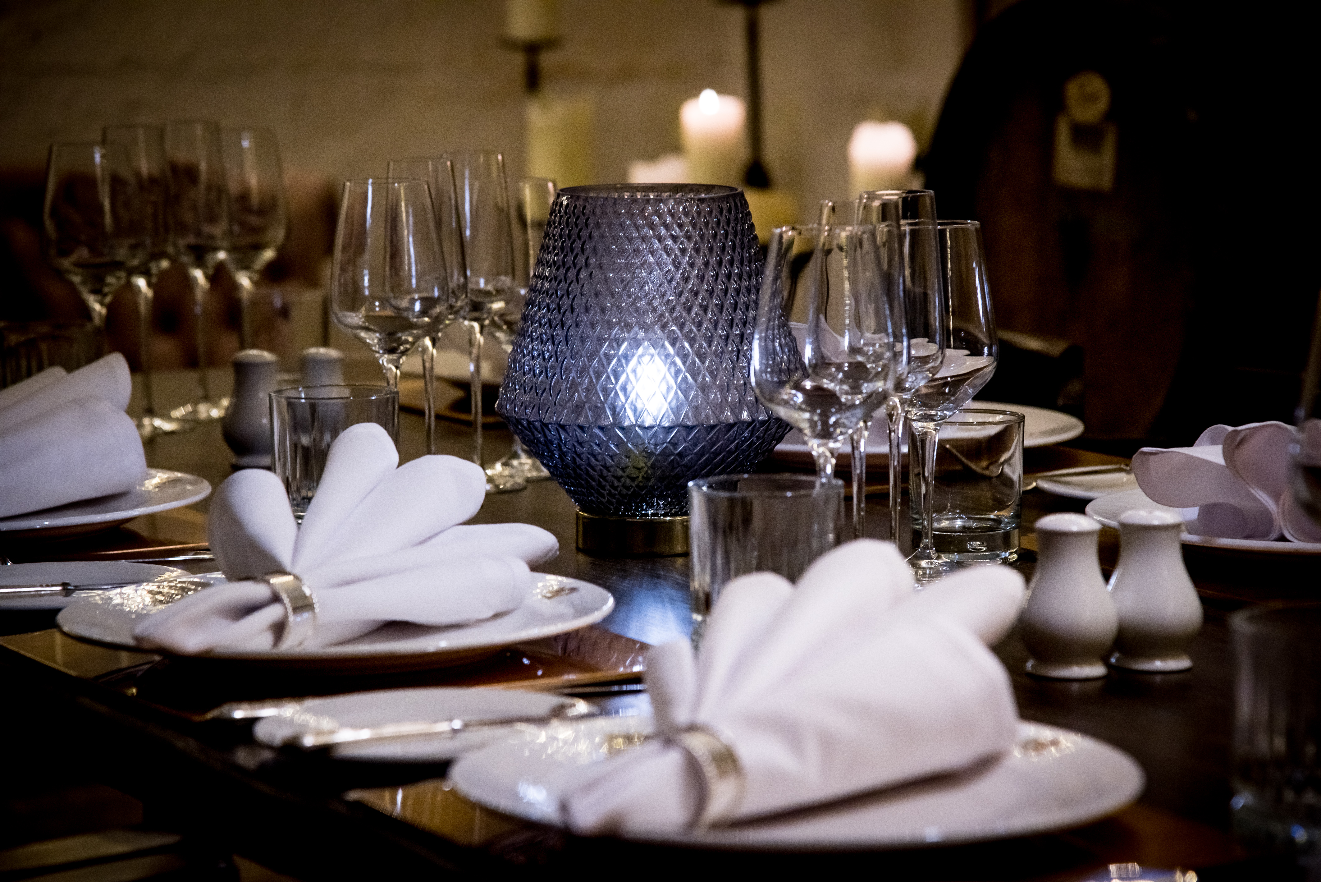 Elegant dining table setup with candles for corporate dinners and special celebrations.