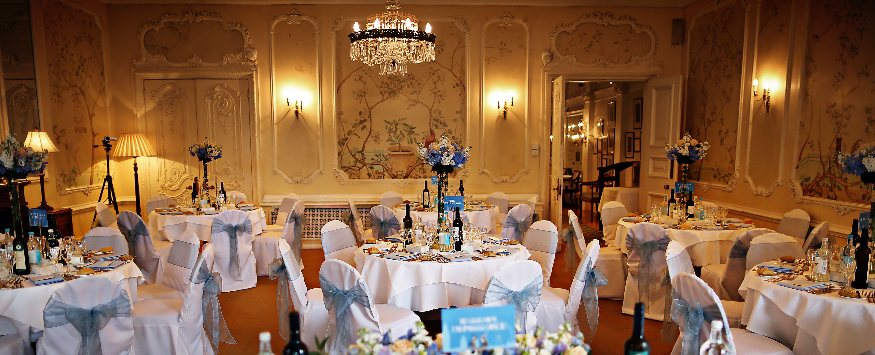 Elegant event space with floral centerpieces, ideal for weddings and corporate events.