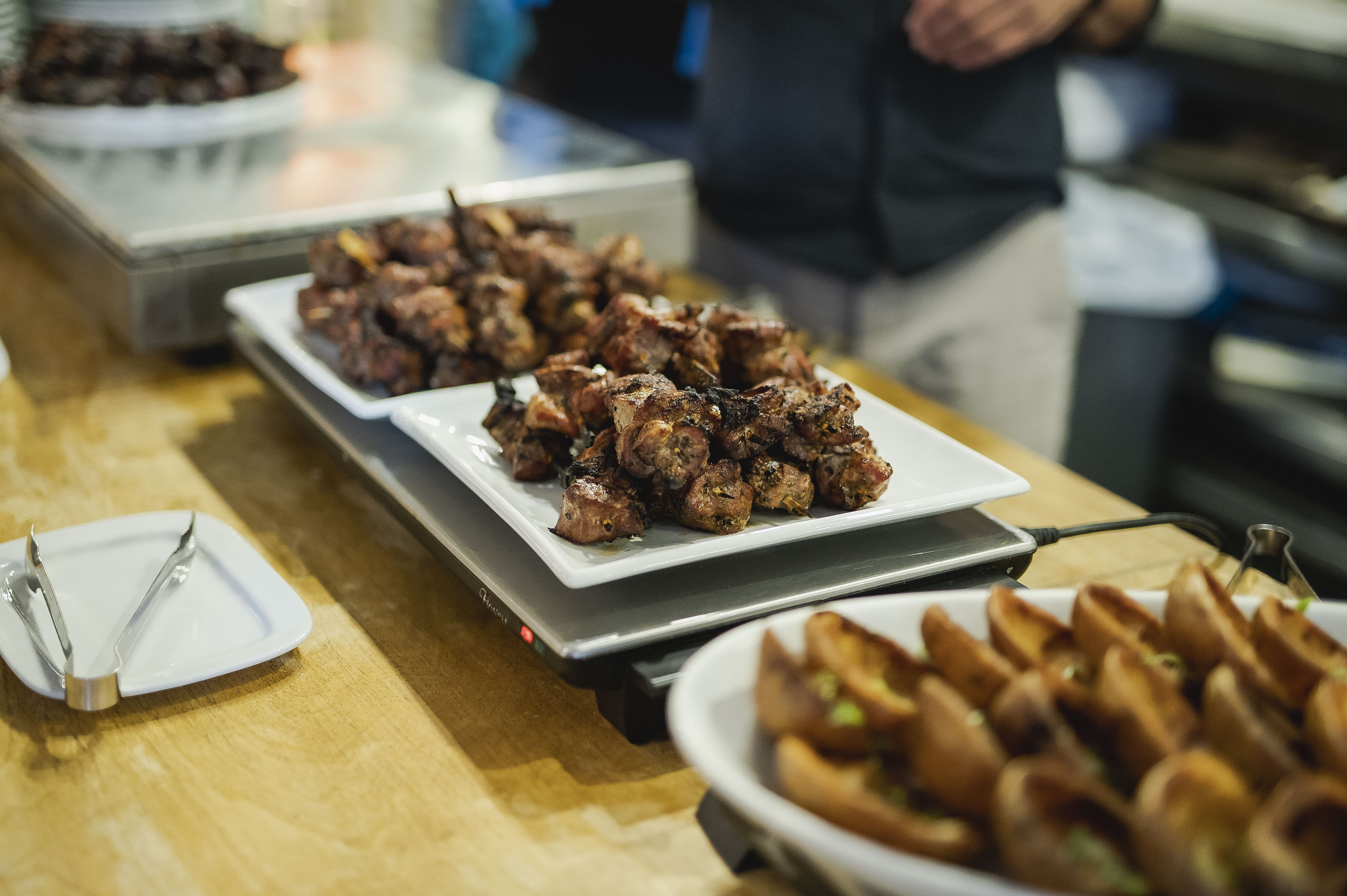 Buffet setup with grilled meats and appetizers at Covent Garden Kitchen event.