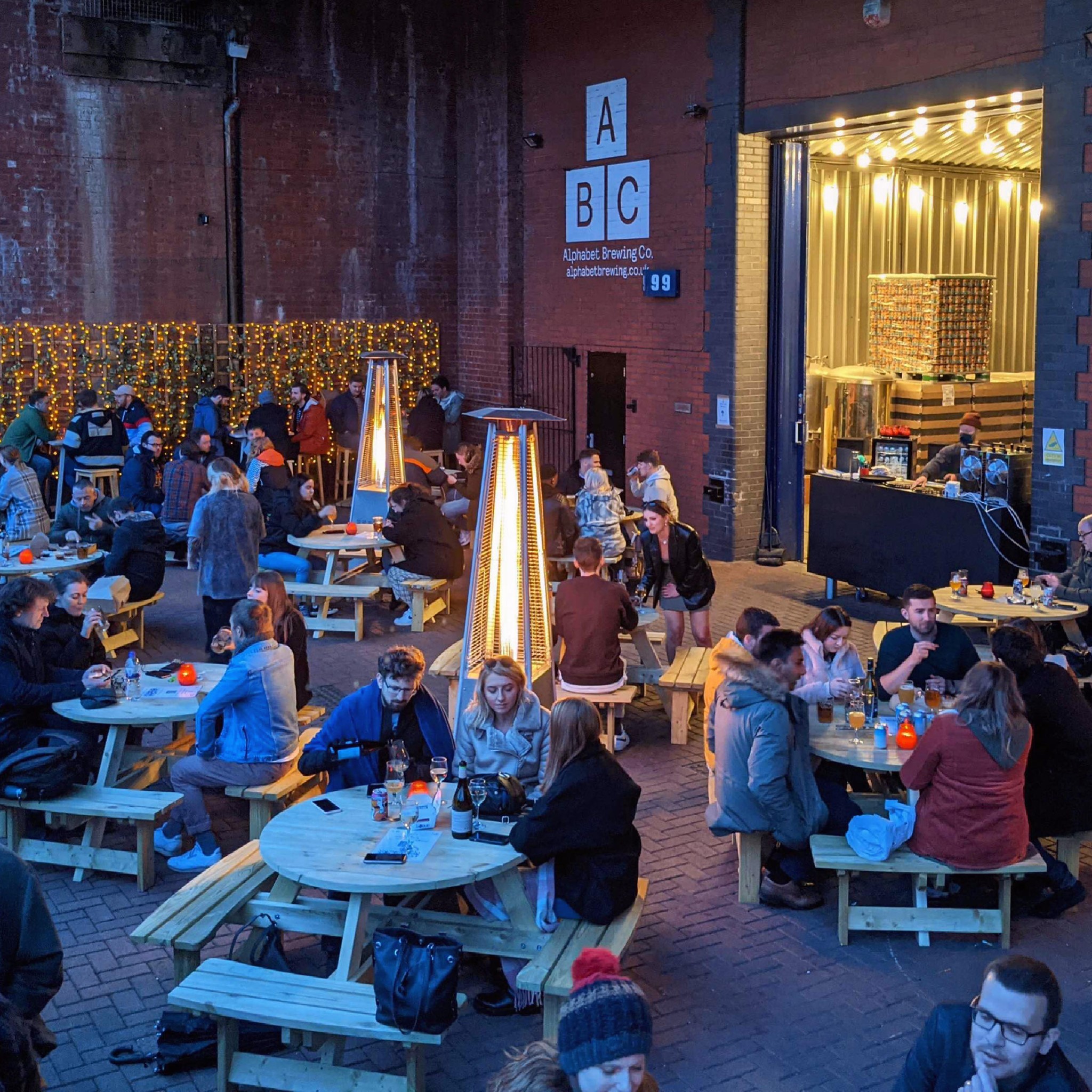 Outdoor event space at Alphabet Brewing Company with picnic tables for social gatherings.