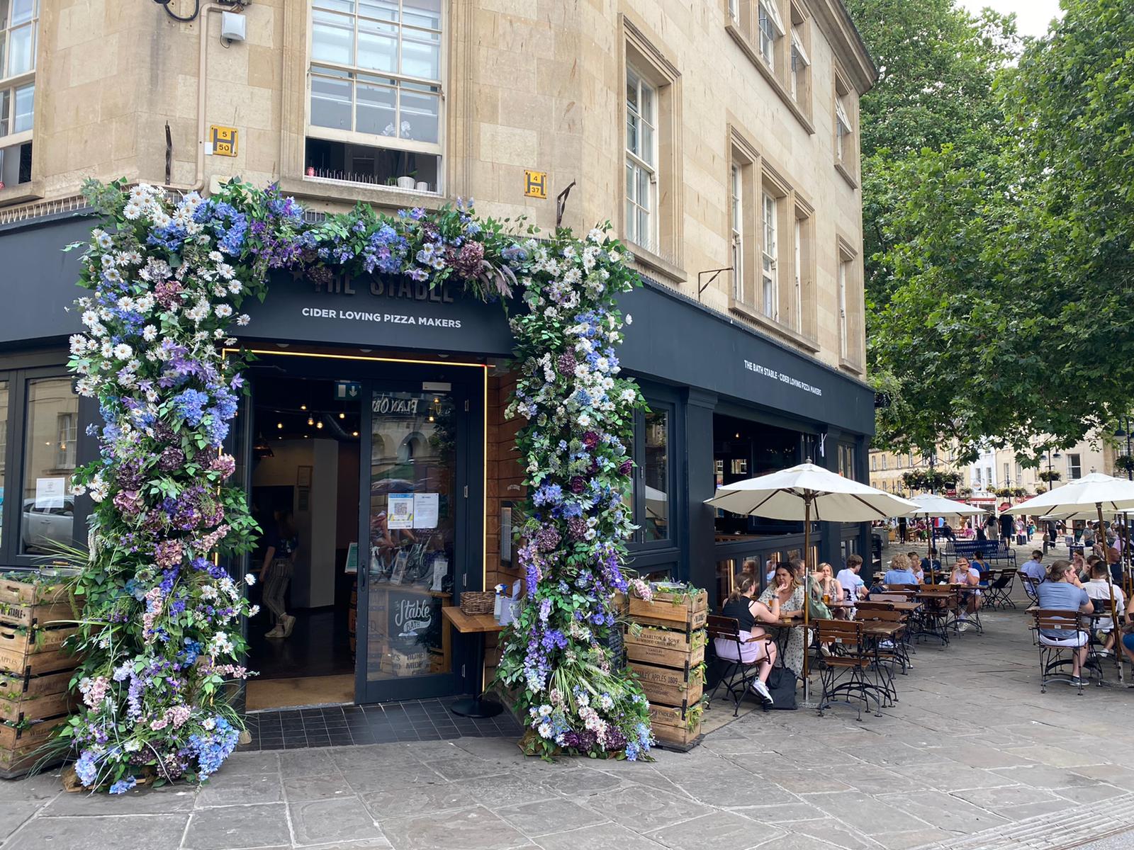 Charming floral entrance at The Bath Stable for versatile event venue hire.