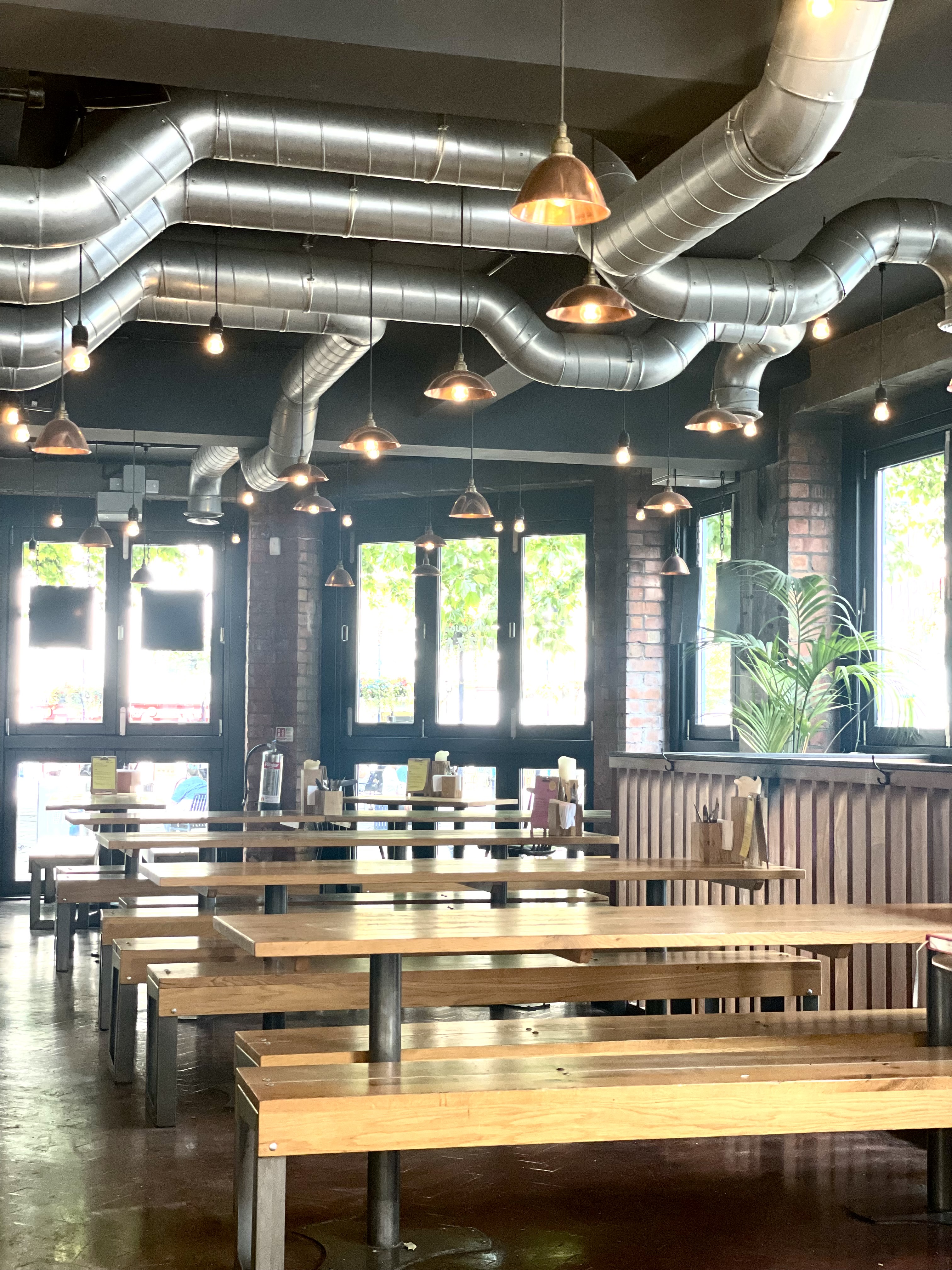 Modern industrial venue with natural light for casual meetings and networking events.