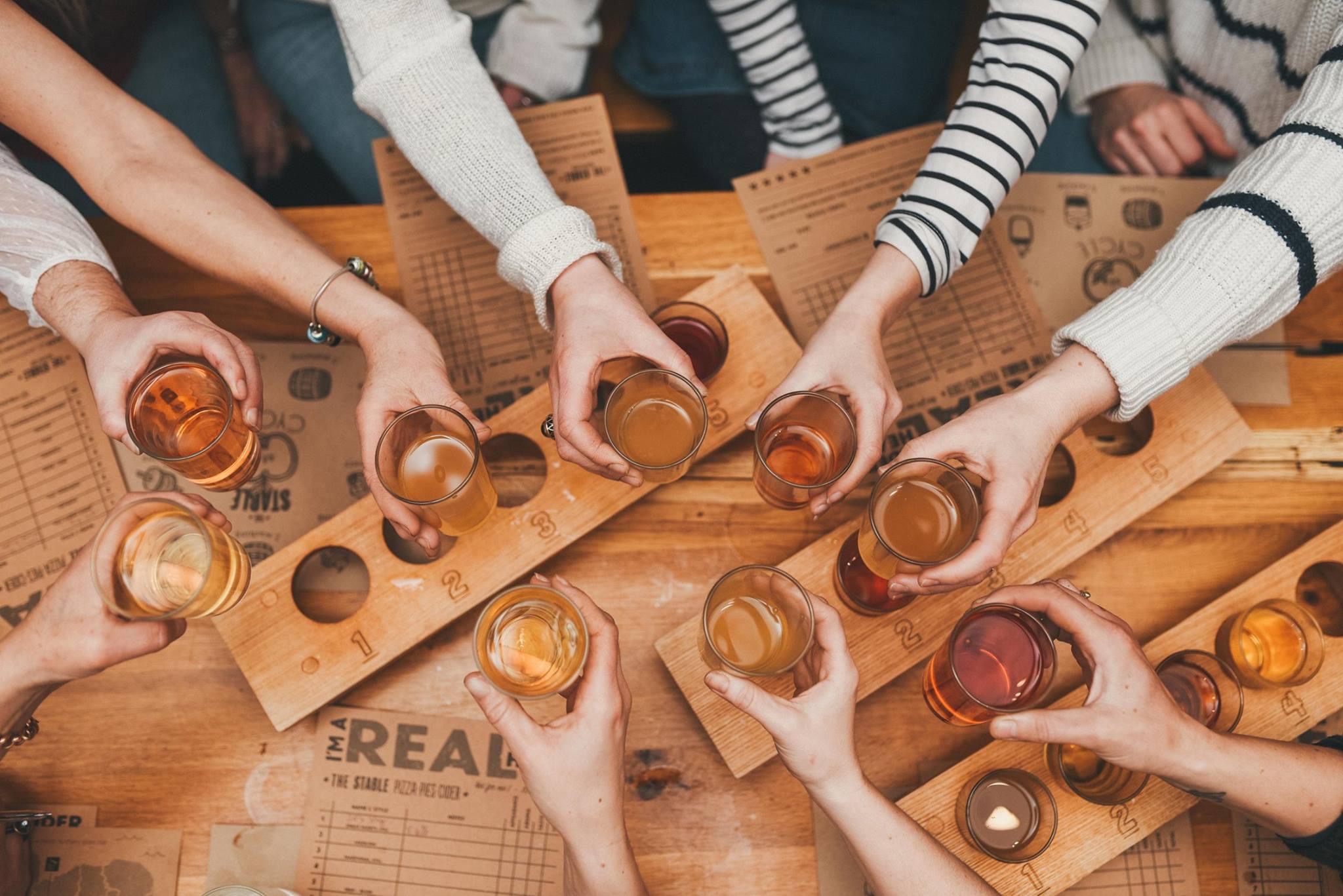 Vibrant tasting event at The Bath Stable with rustic wooden flight board, ideal for gatherings.