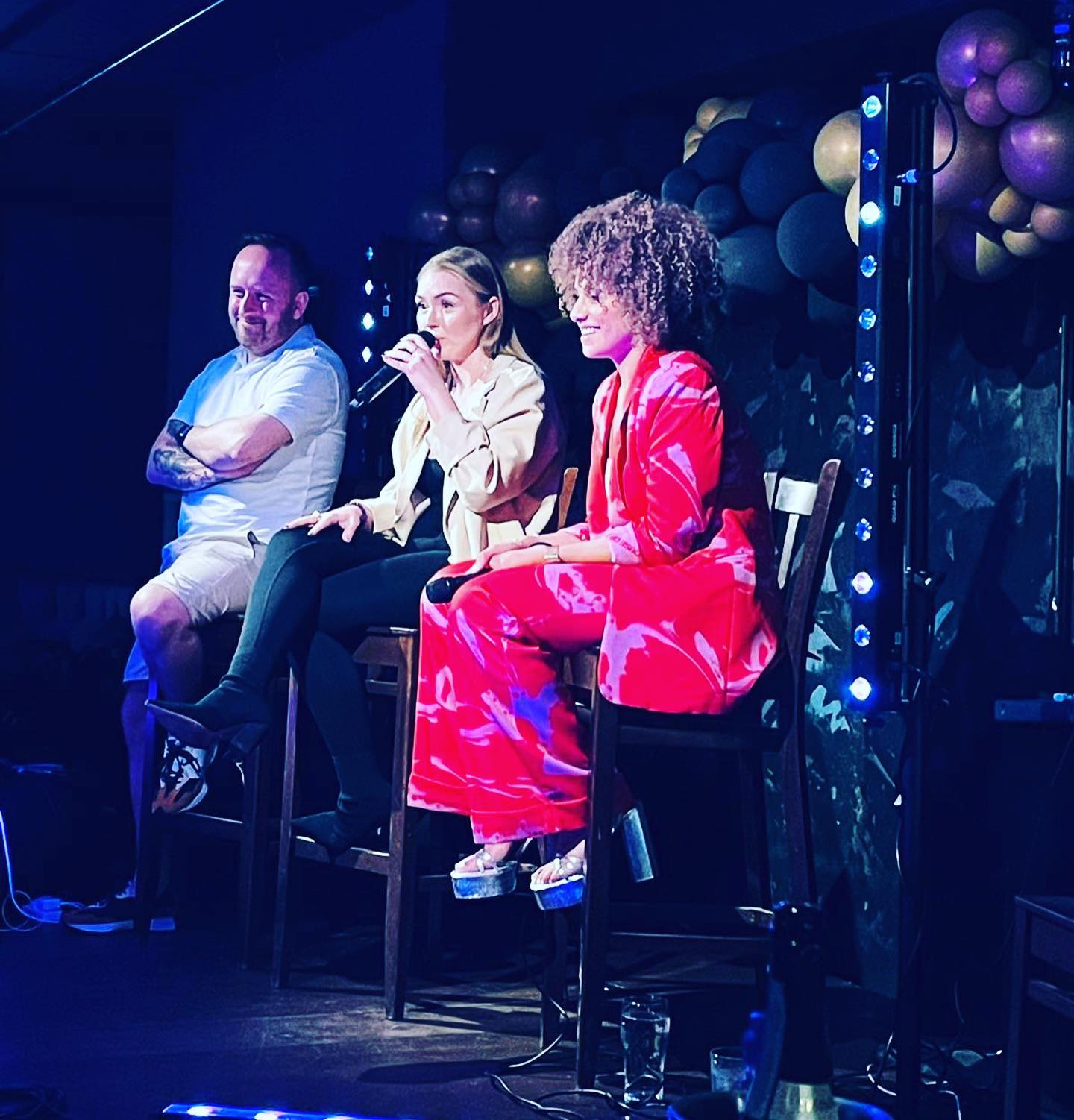 Dynamic panel discussion at The Fitzgerald Manchester with colorful lighting and networking.