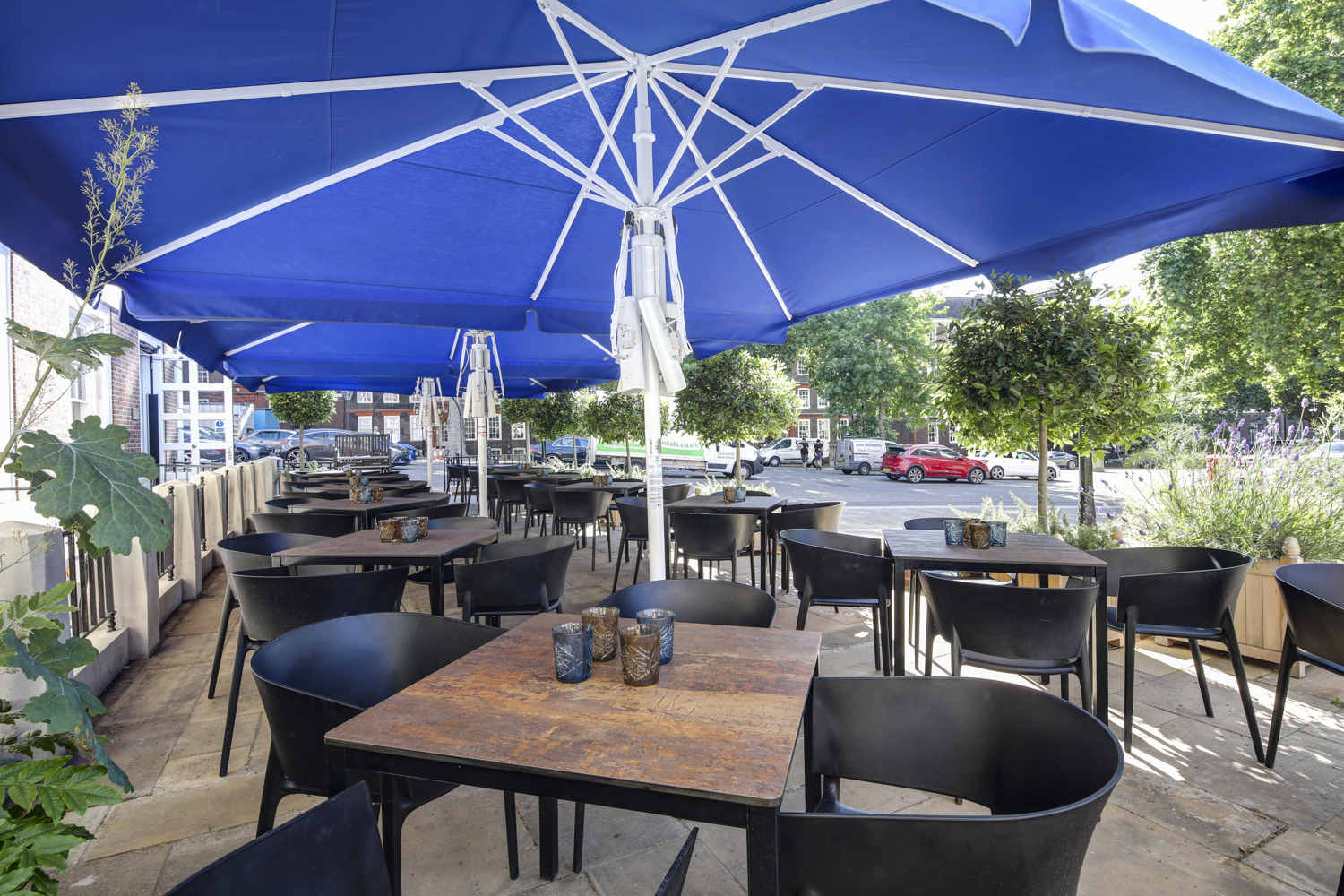 Outdoor dining at Pegasus Bar, Inner Temple, with blue umbrellas for summer events.