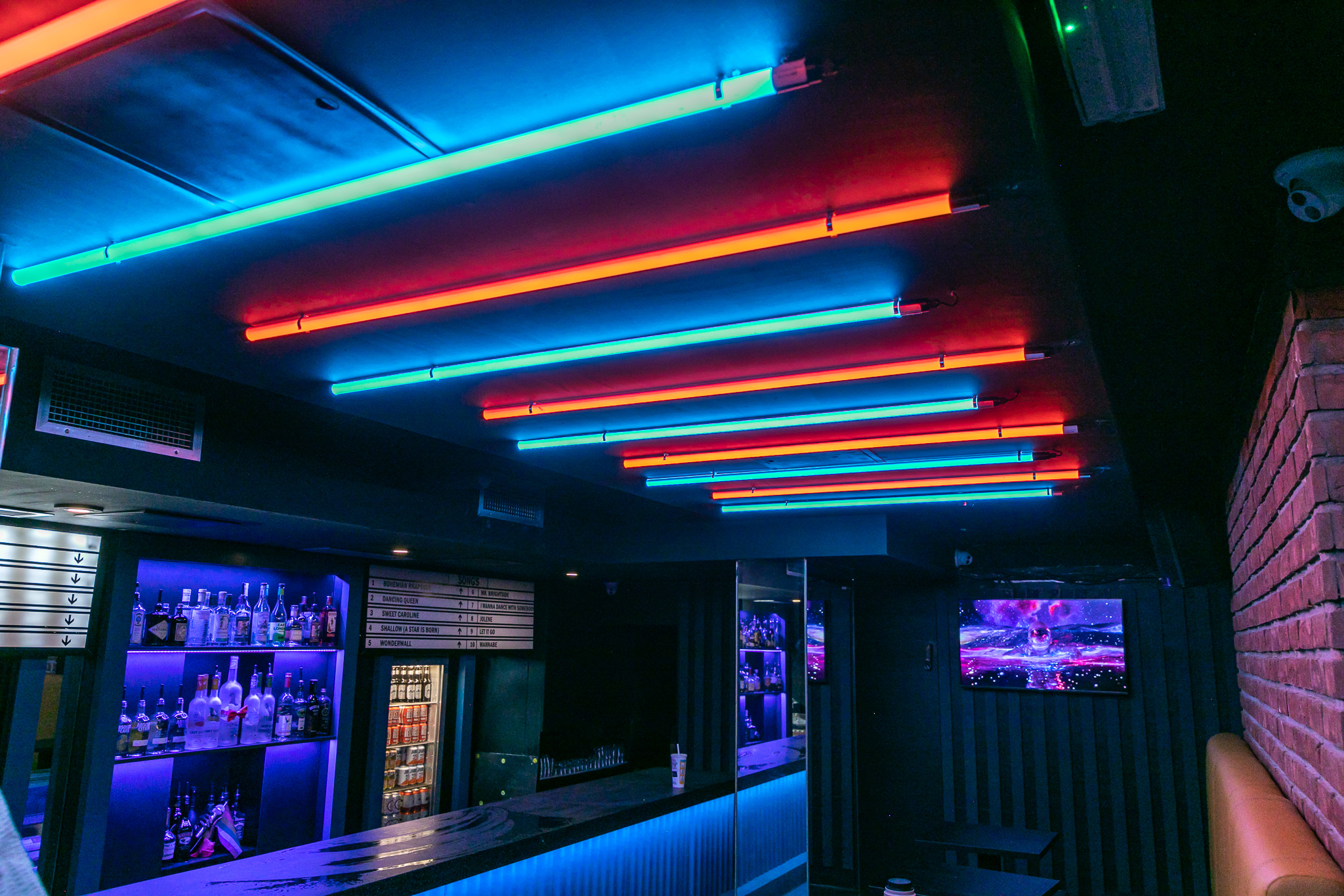 Private karaoke rooms at Lucky Voice Soho with vibrant neon lighting for social events.