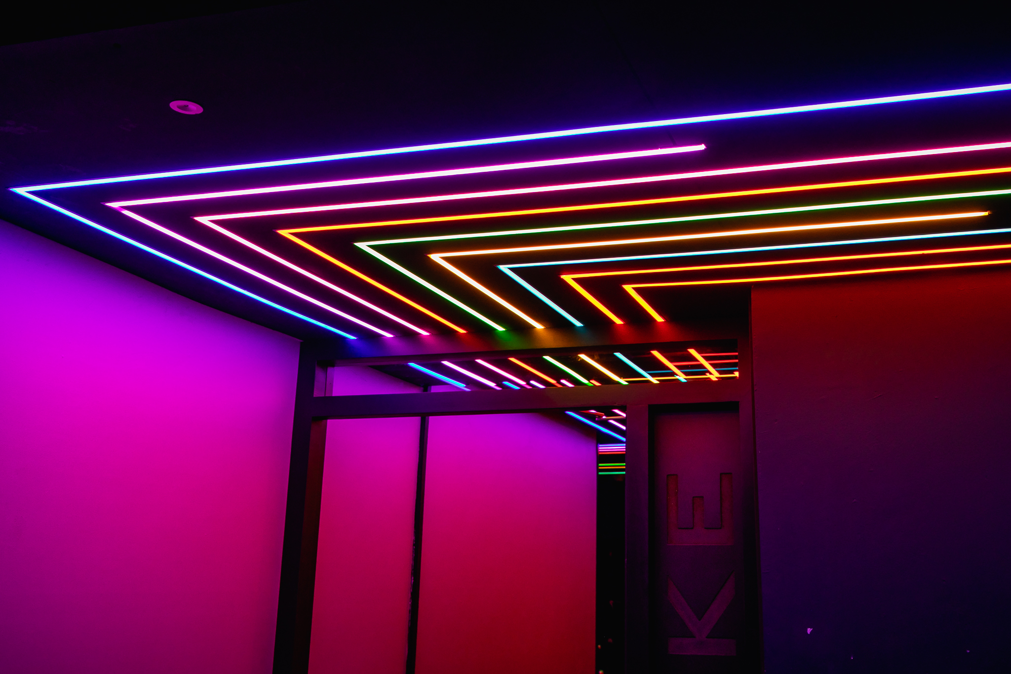 Vibrant private karaoke room with neon lights for parties and events at Lucky Voice Soho.