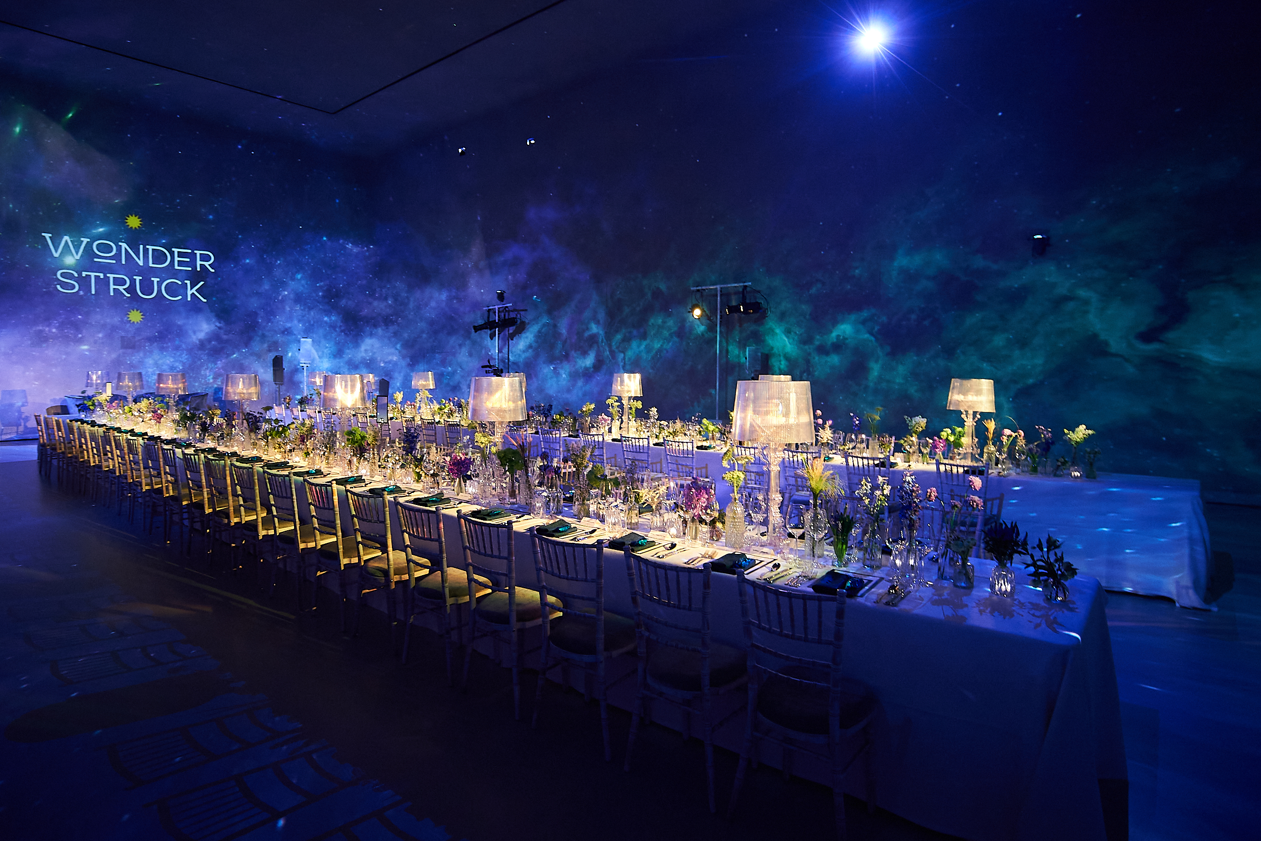 Elegant event setup with floral decor for a WONDERSTRUCK gala or corporate dinner.