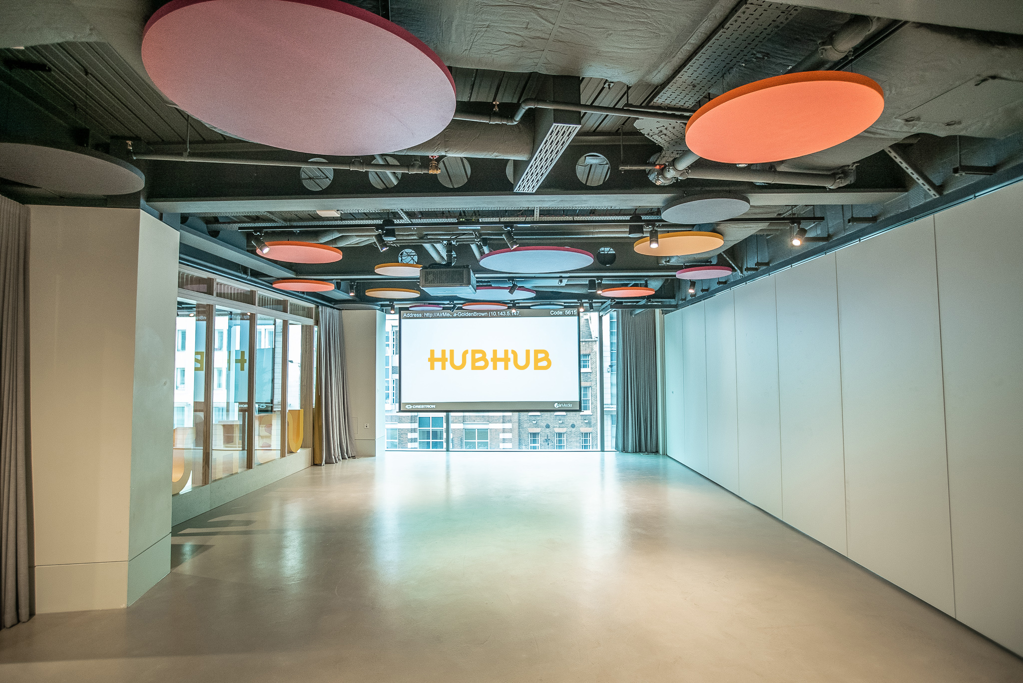 Modern Half Event Space in HubHub with acoustic panels for corporate meetings and workshops.