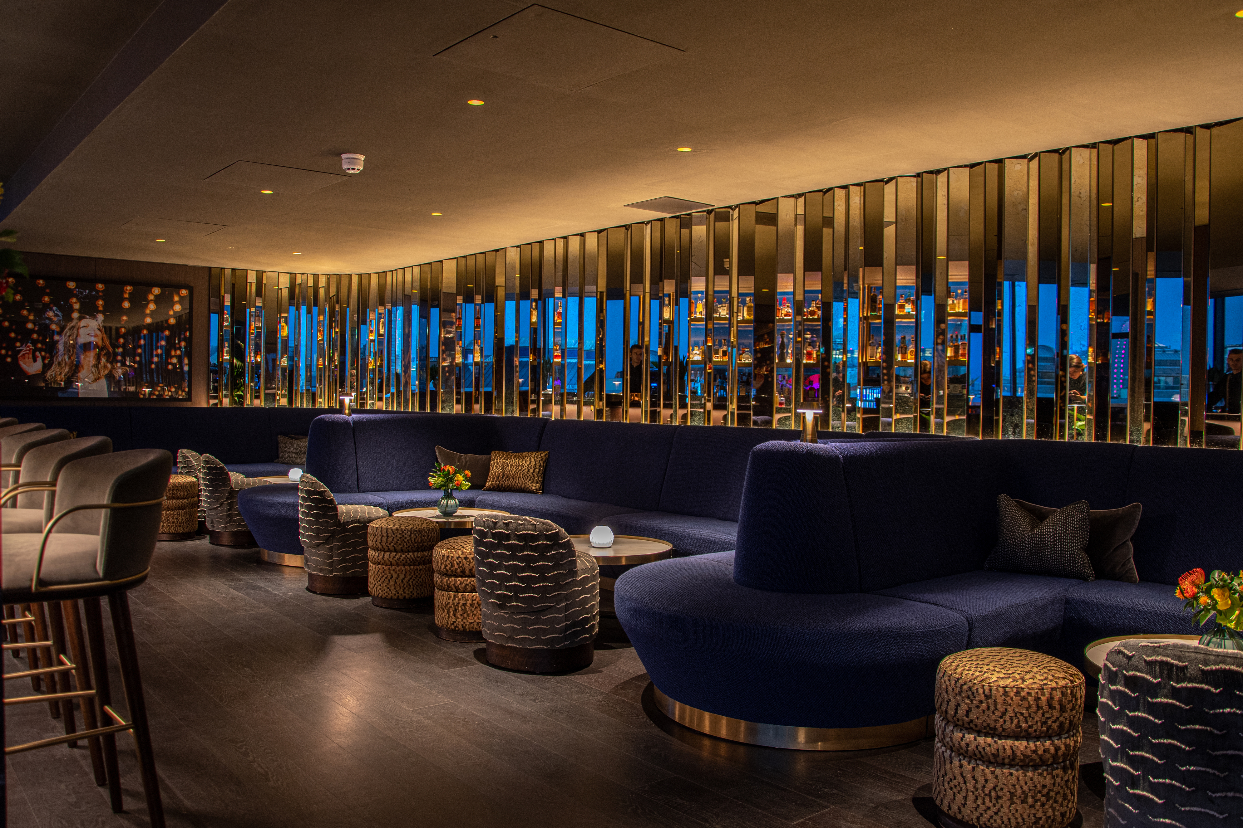 Sophisticated AMANO Rooftop lounge with plush seating for networking events and gatherings.