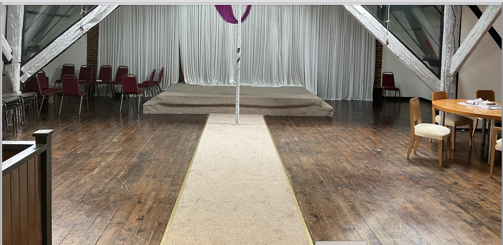 Versatile Kingdom Hall event space with stage, ideal for weddings and corporate meetings.