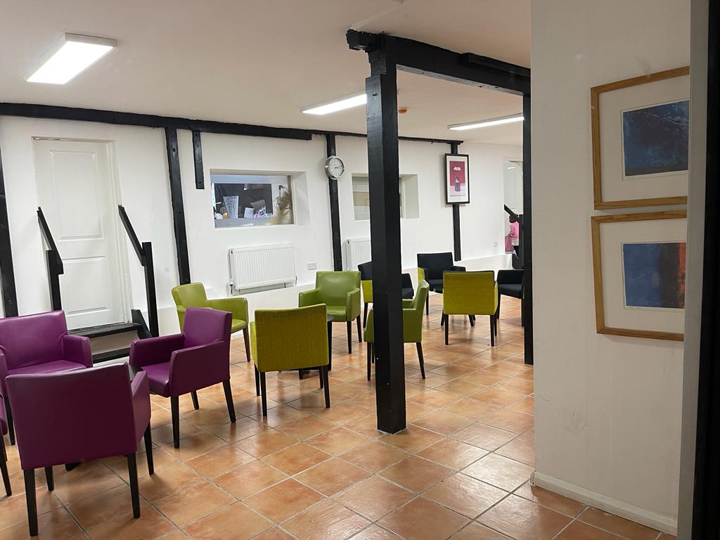 Versatile Kingdom Hall meeting space with colorful chairs for workshops and discussions.