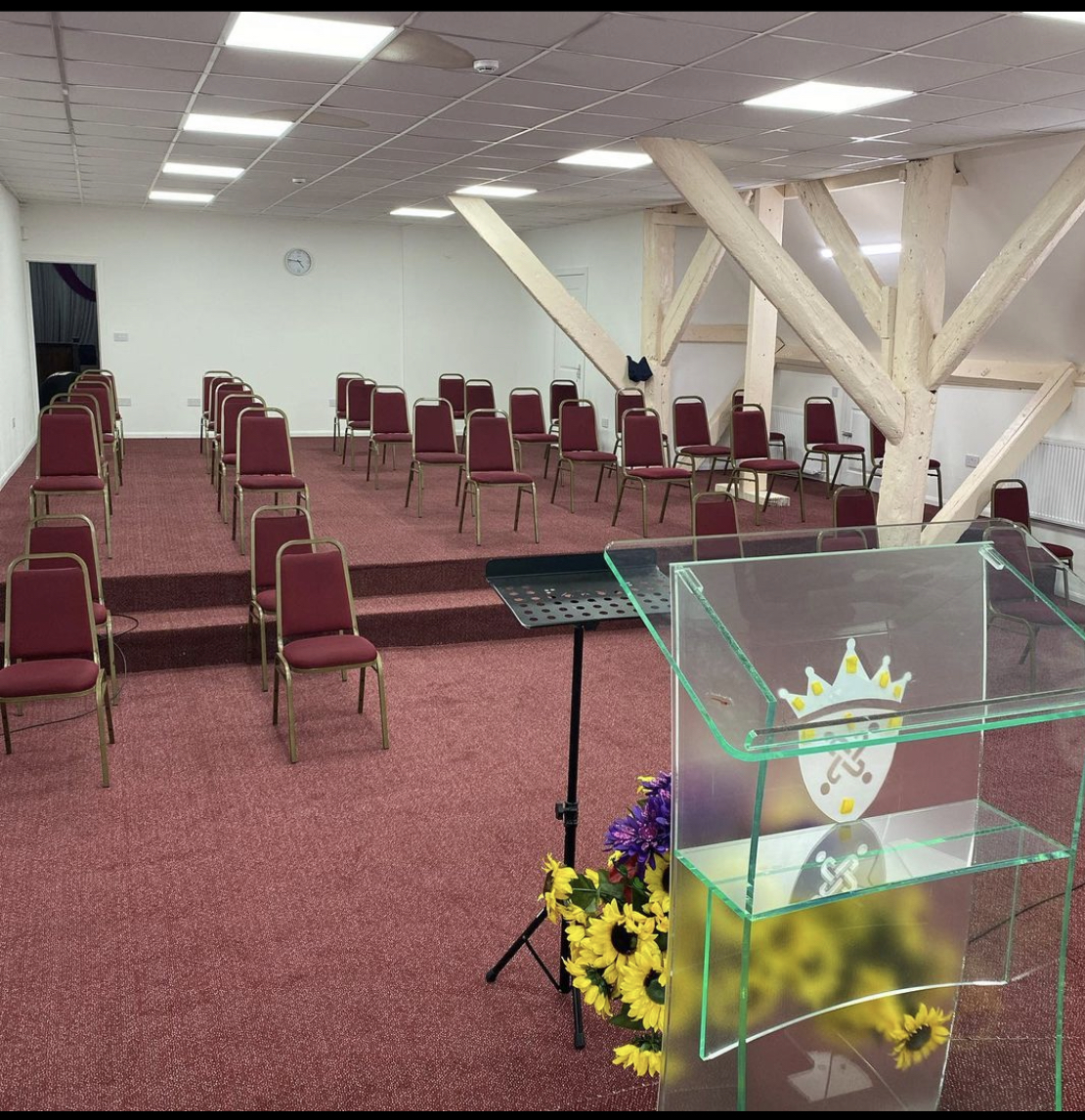 Kingdom Hall meeting space with empty chairs, ideal for presentations and social distancing.