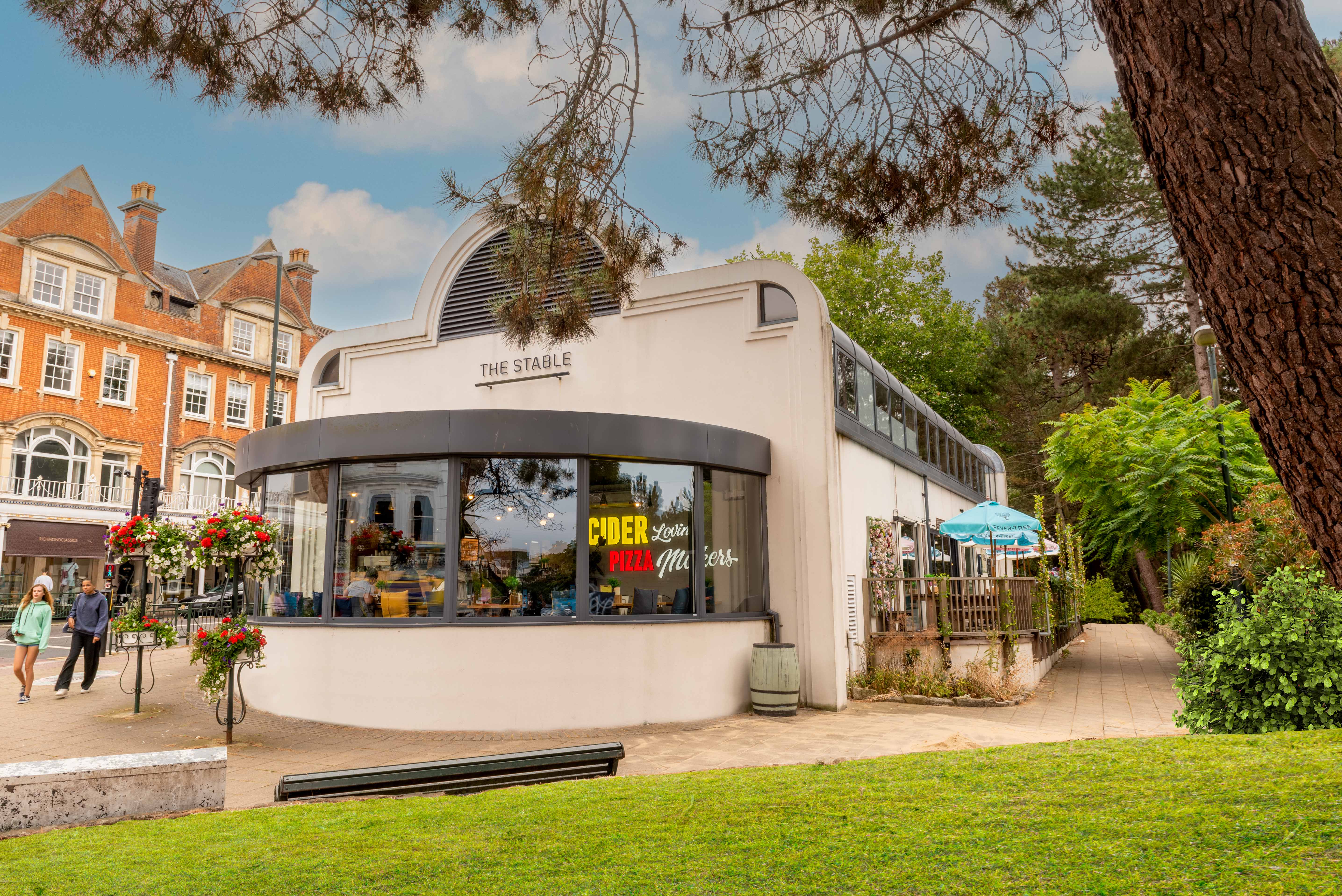 Charming Bournemouth venue with large windows for meetings and events, surrounded by greenery.