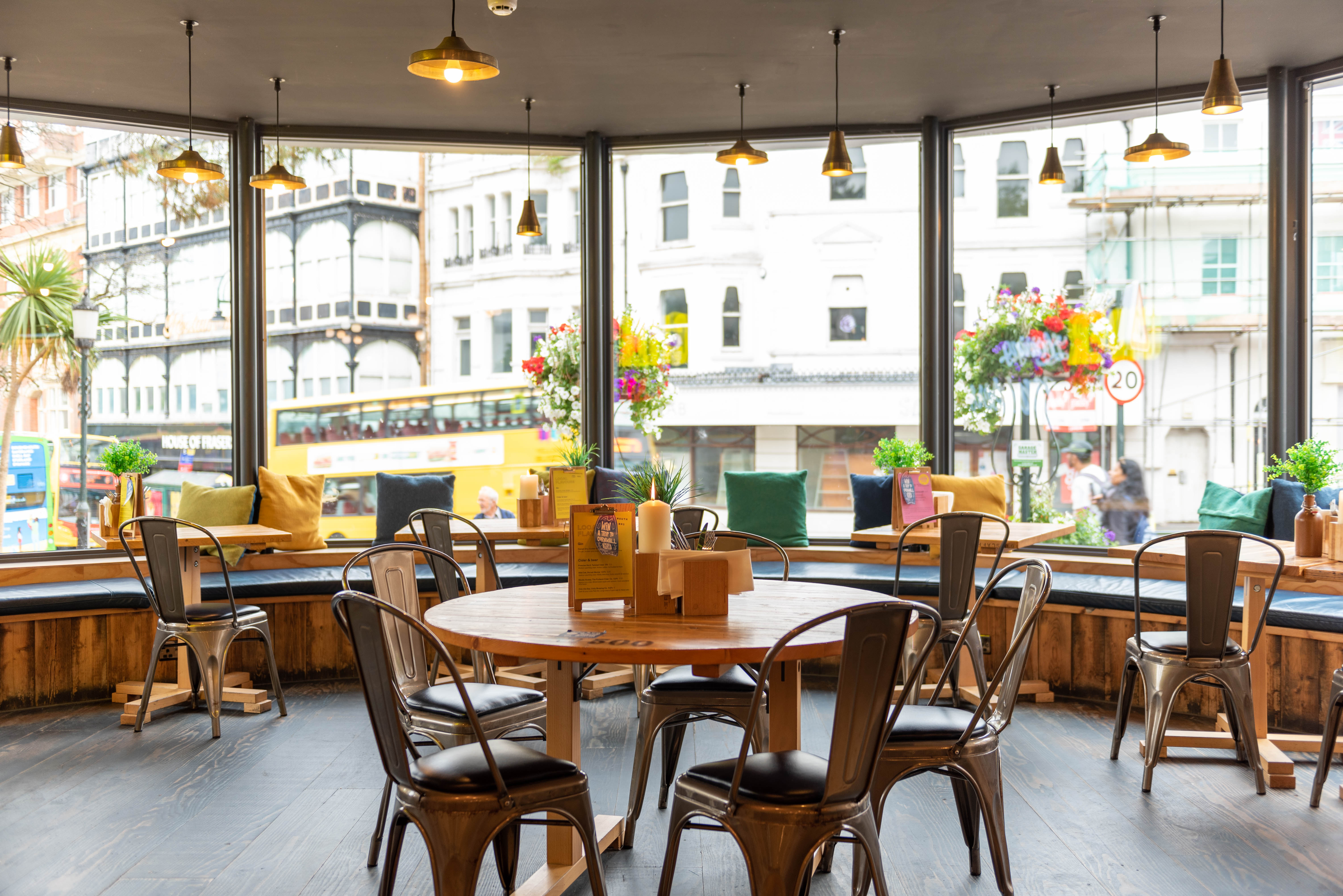 Bright event space with large windows, ideal for casual meetings and networking.