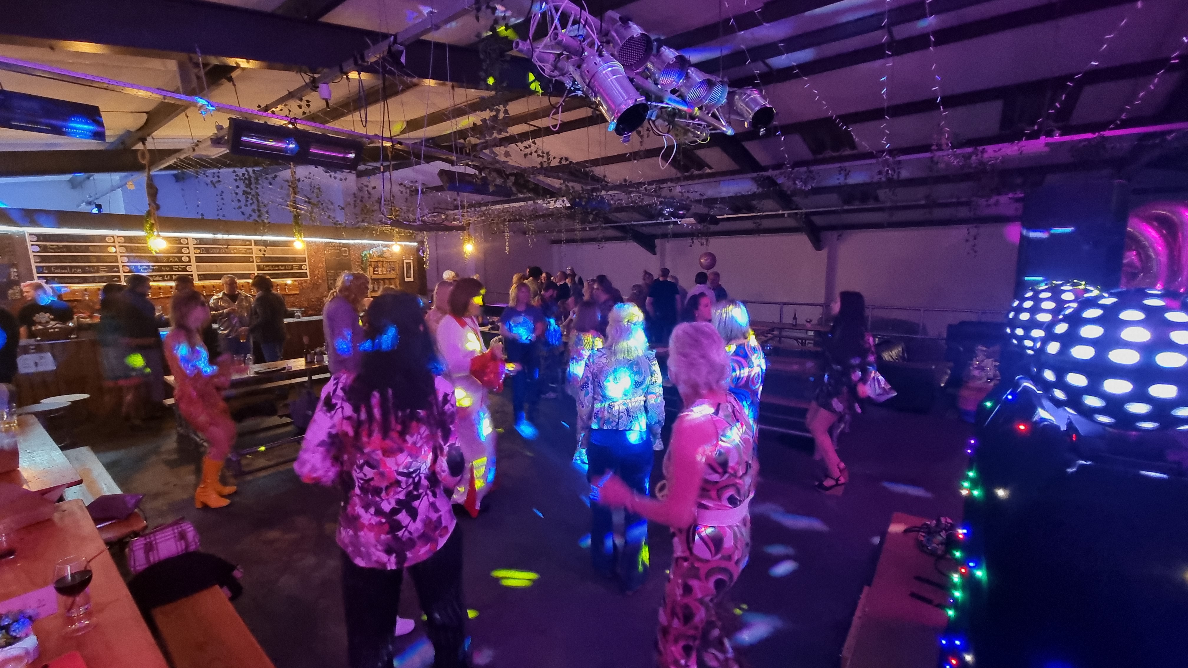 Vibrant dance party at The Mezzanine, featuring colorful lighting and socializing opportunities.