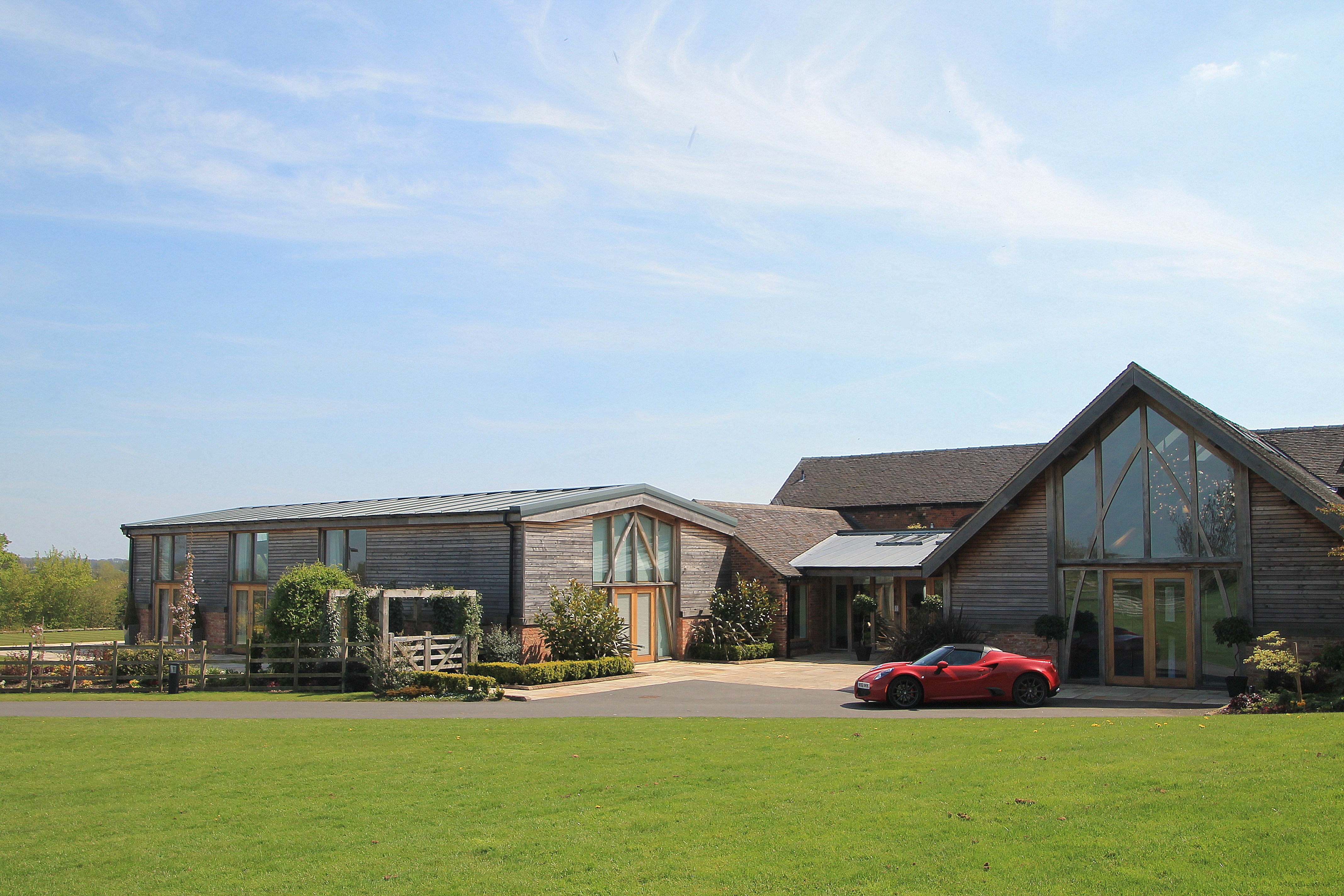 Mythe Barn corporate events venue with modern wooden exterior and natural light.