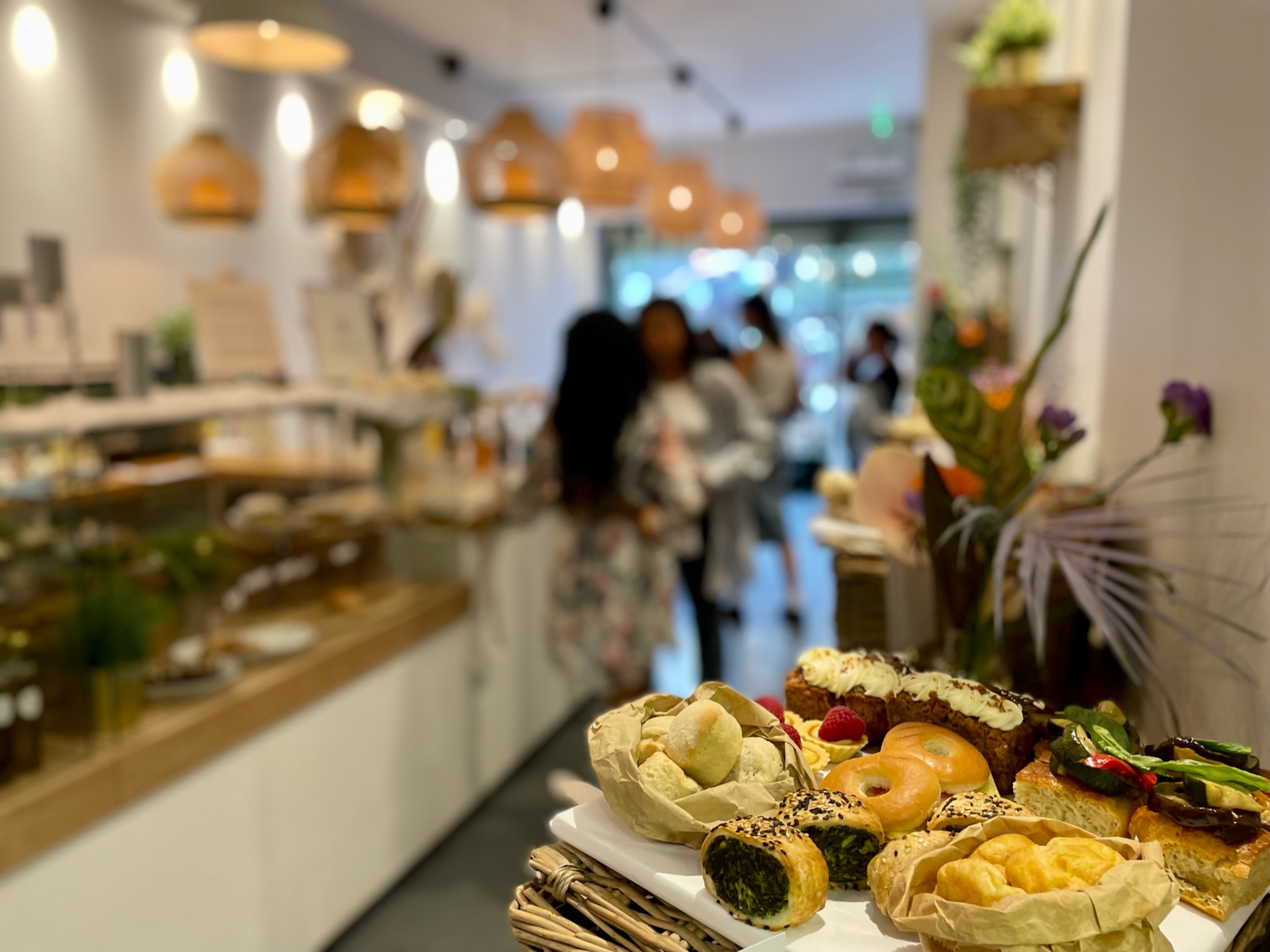 Gourmet snack spread at Luxury Picnic Cafe for networking event, warm lighting ambiance.